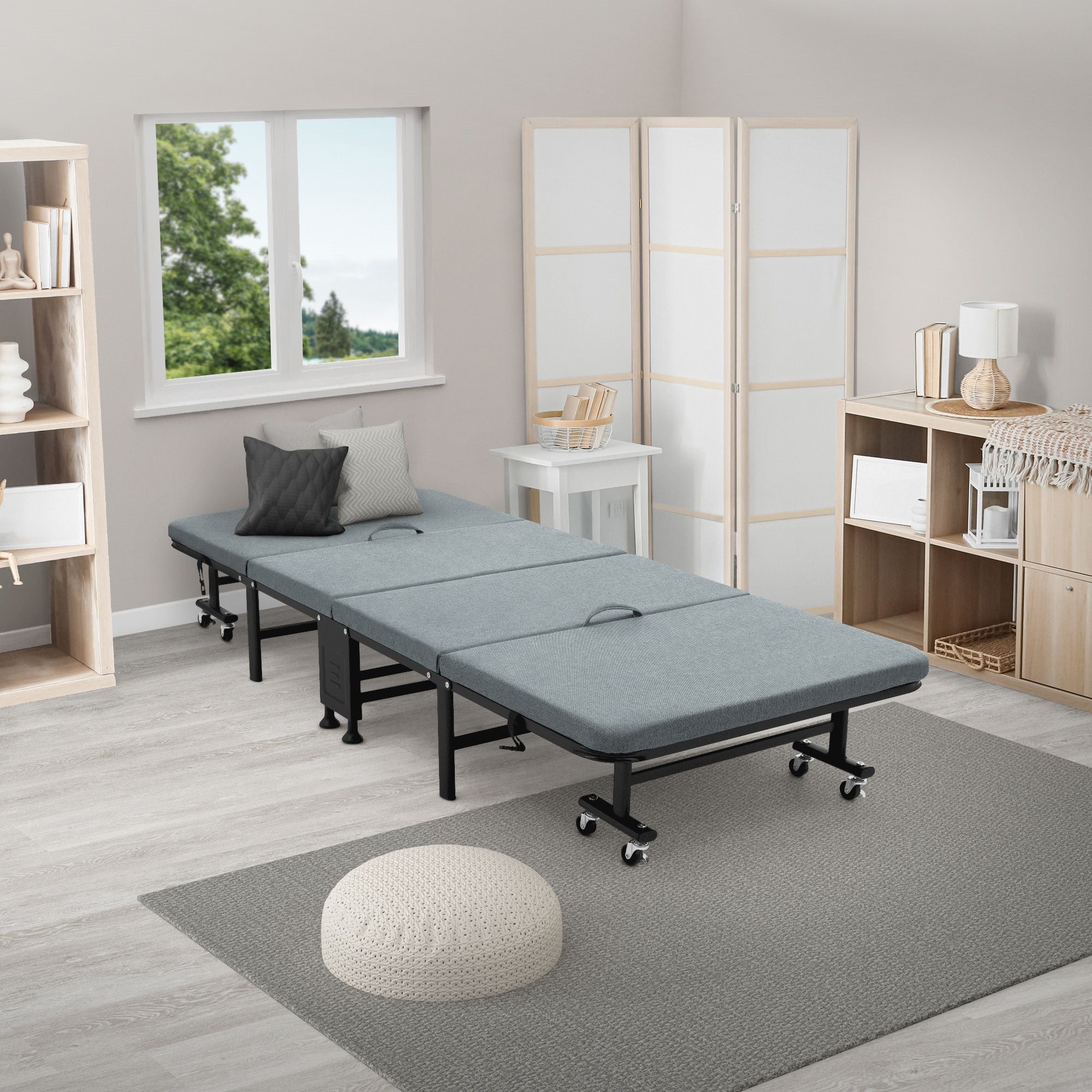 Folding bed in a bright room with a window and shelves.