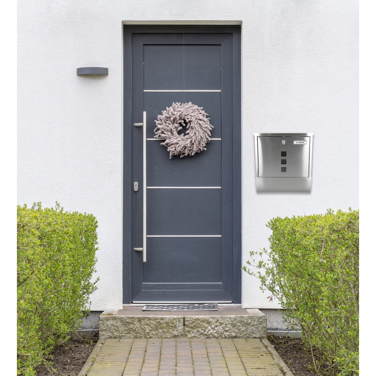Front door with wreath and silver mailbox.