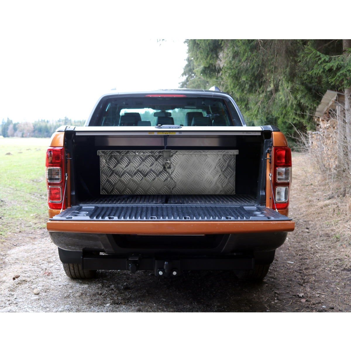 Open loading area of a pickup truck with a toolbox.