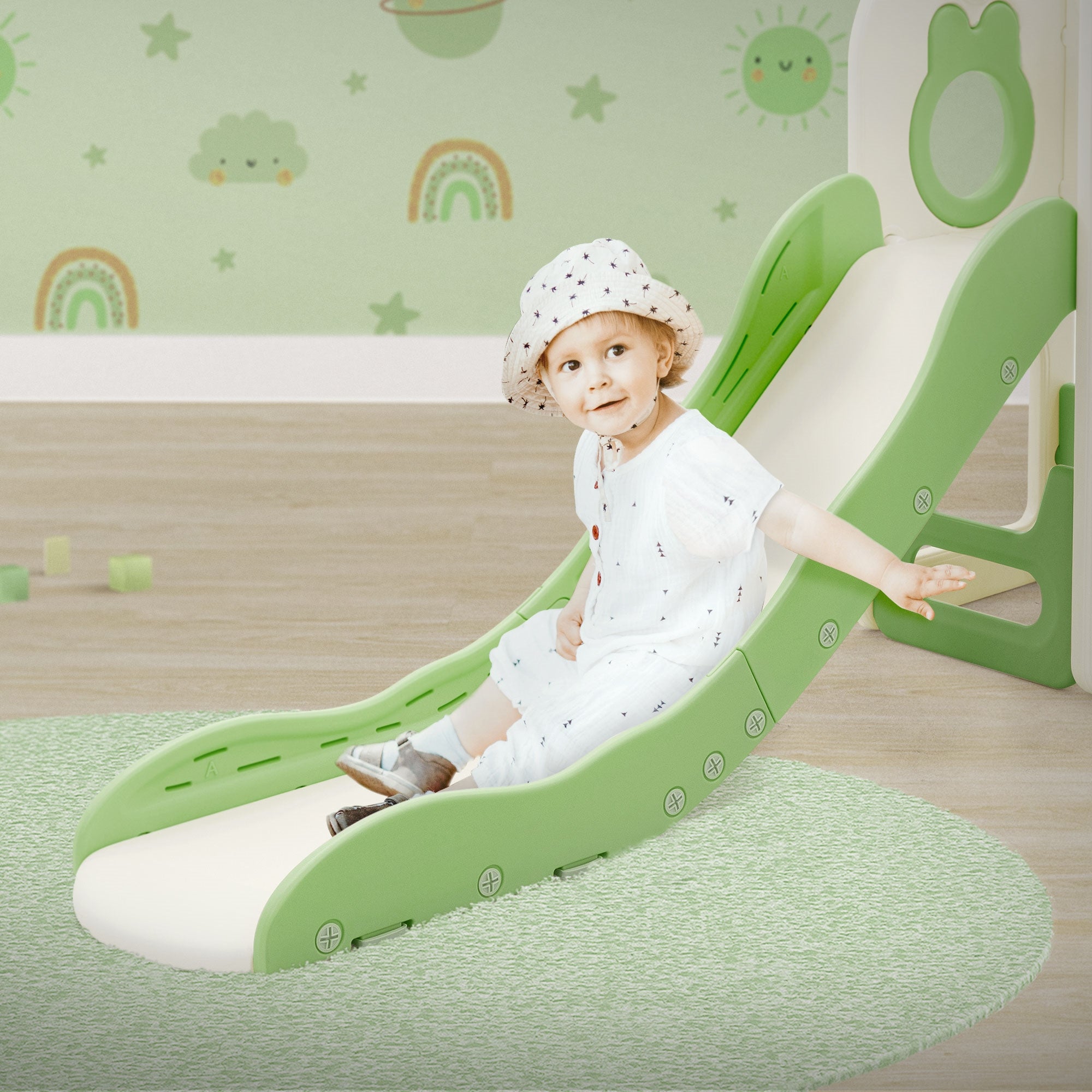 Child on a green slide, playing in a bright room.