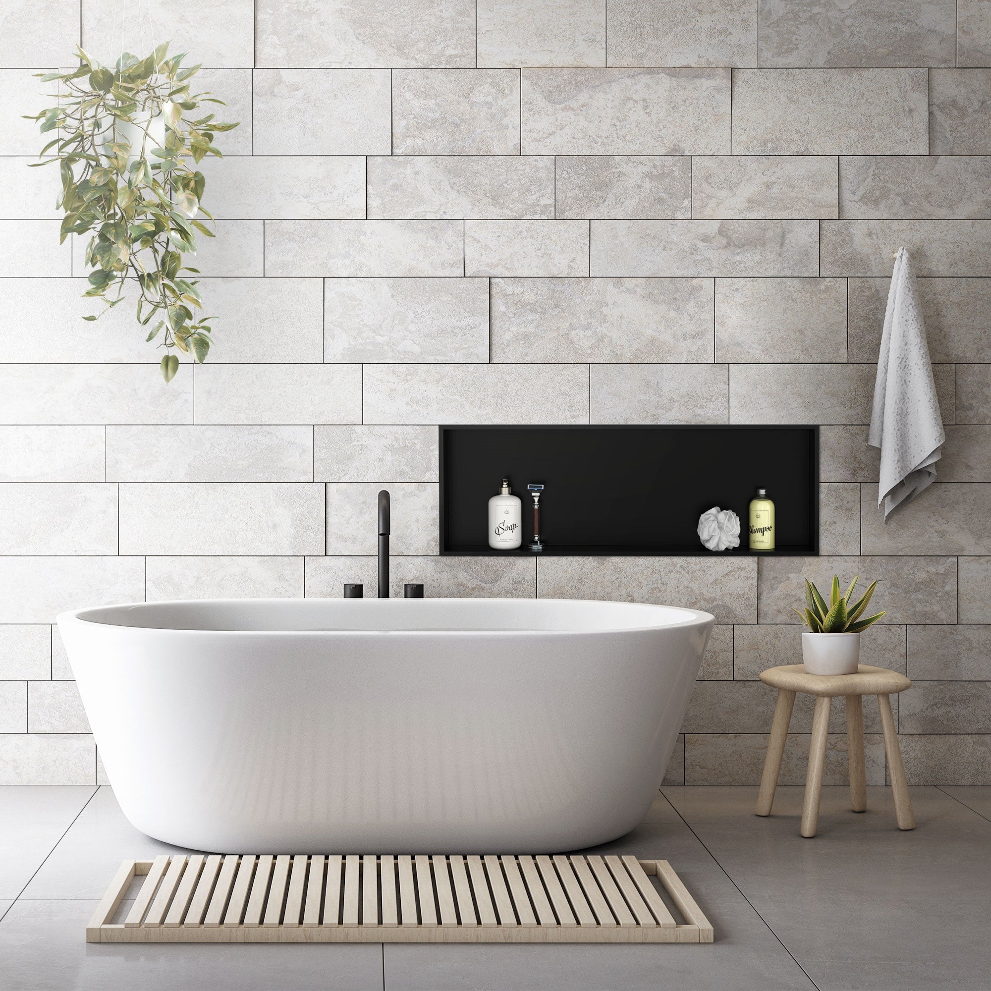 Bathroom with freestanding bathtub and black wall niche.