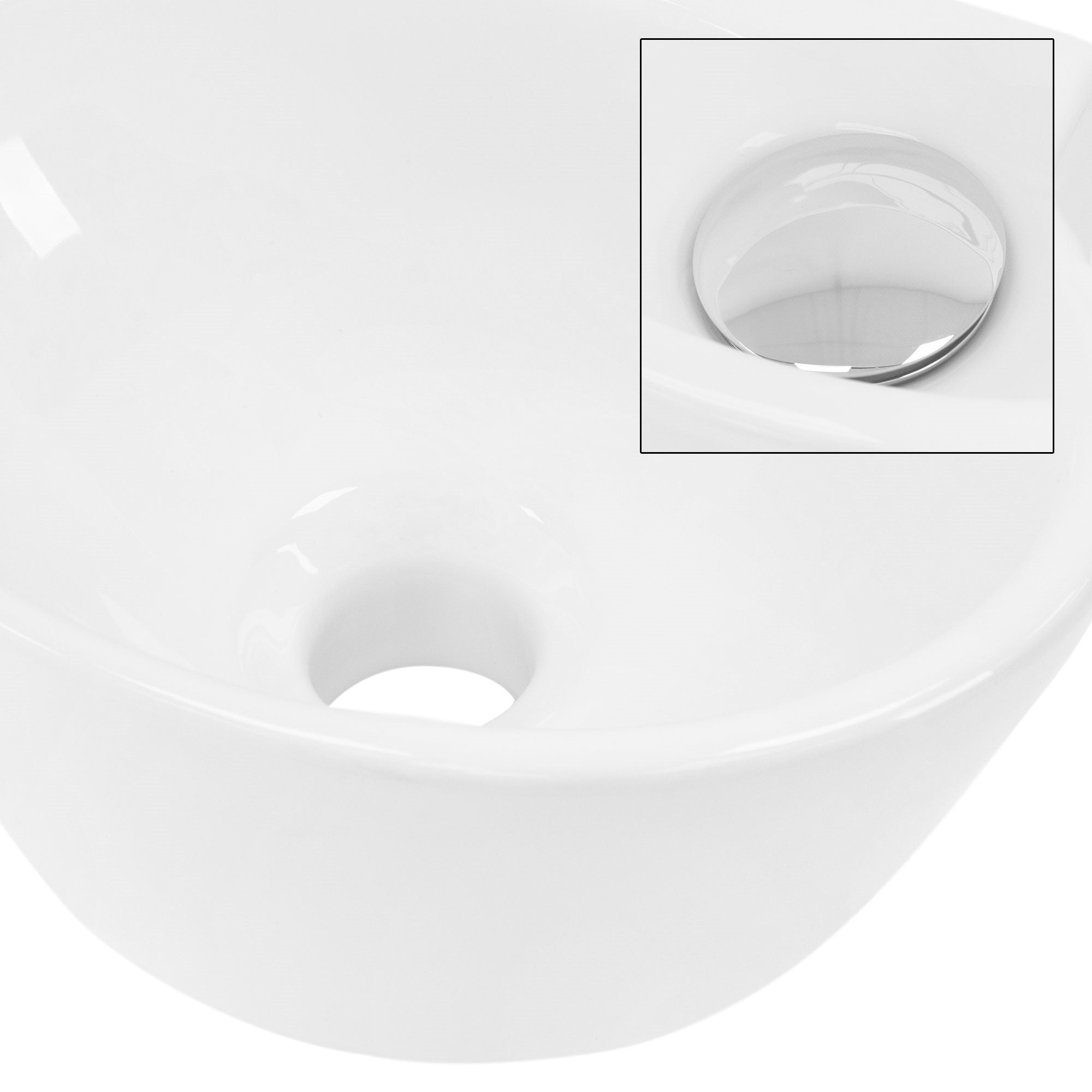 Weißes Waschbecken mit Abflussloch und glänzendem Abdeckstopfen.