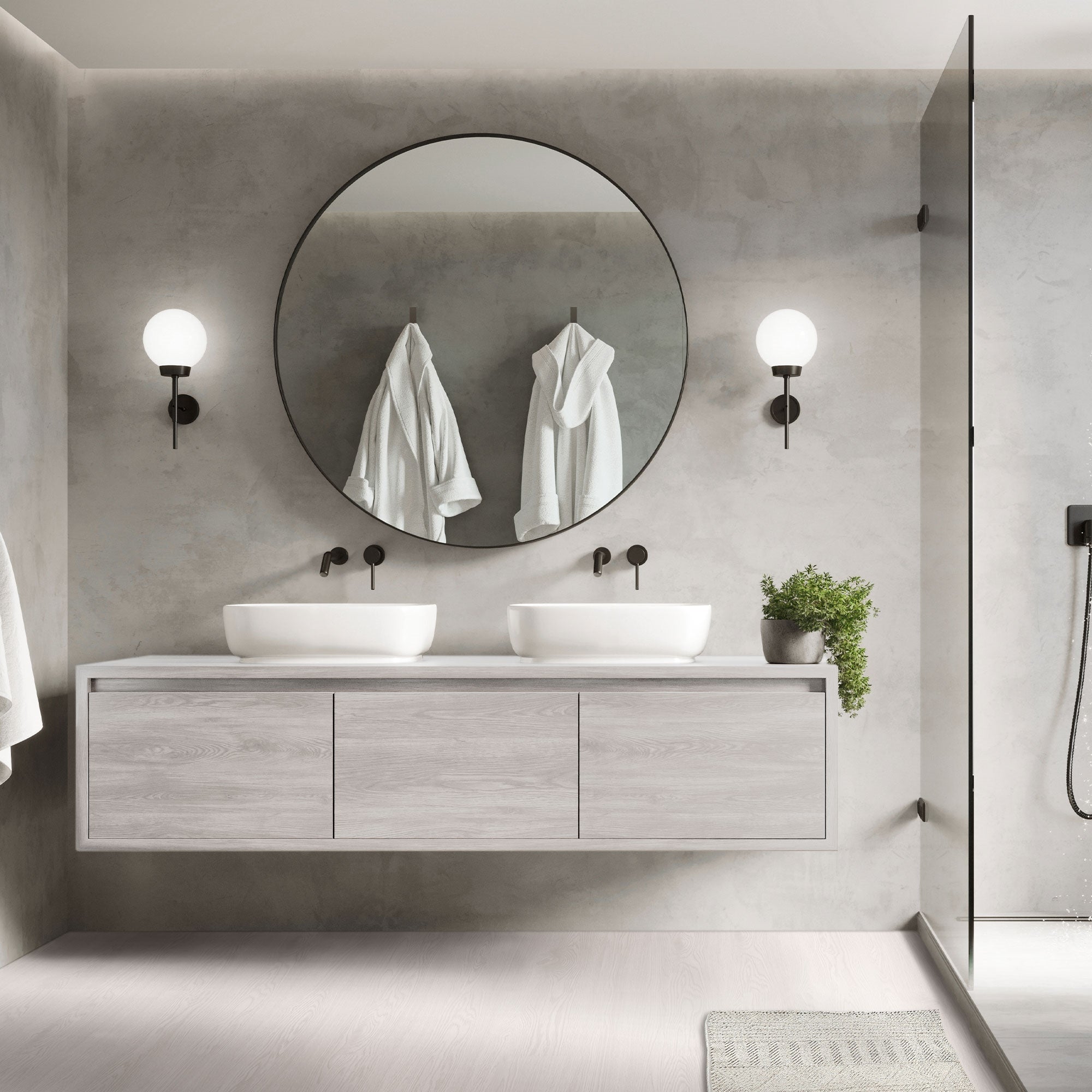 Modernes Badezimmer mit runden Spiegel und zwei Waschbecken.
