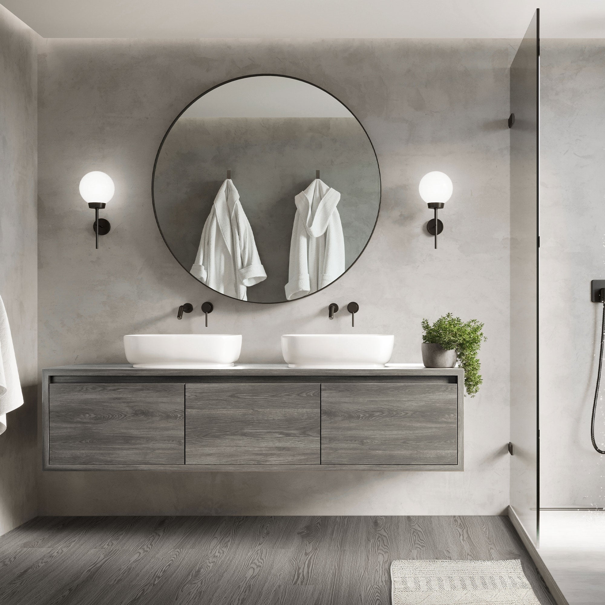 Salle de bain moderne avec miroir rond, deux lavabos et serviettes.