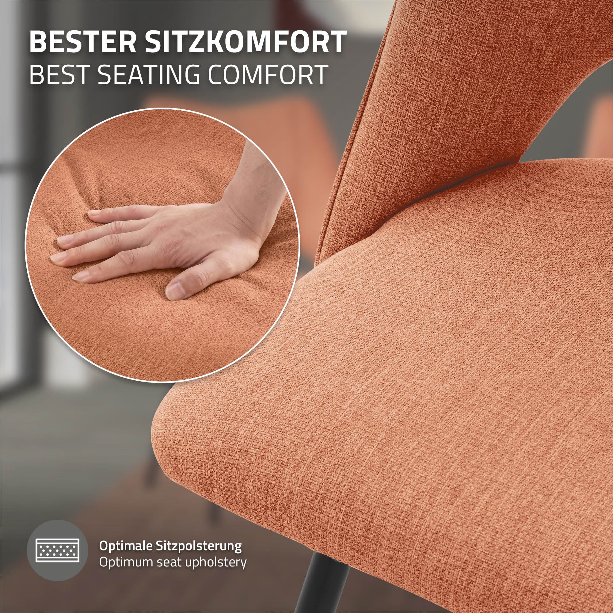 Nahaufnahme eines orangen Stuhls mit einer Hand, die die Polsterung testet.