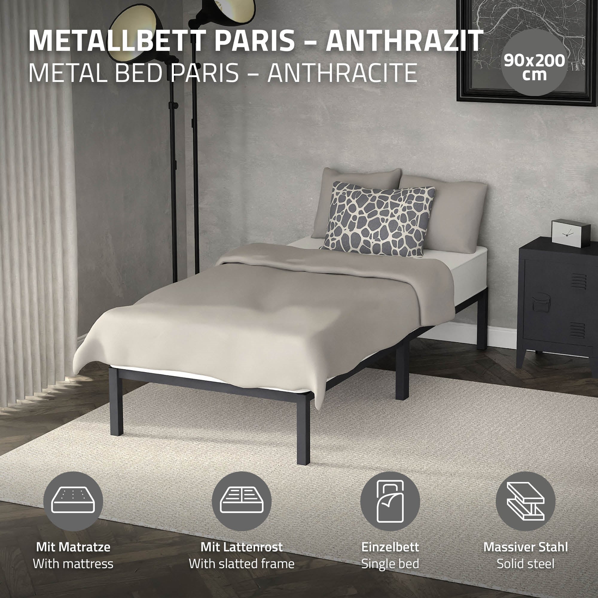 Ein anthrazitfarbenes Metallbett mit Matratze und Kissen auf einem Teppich.