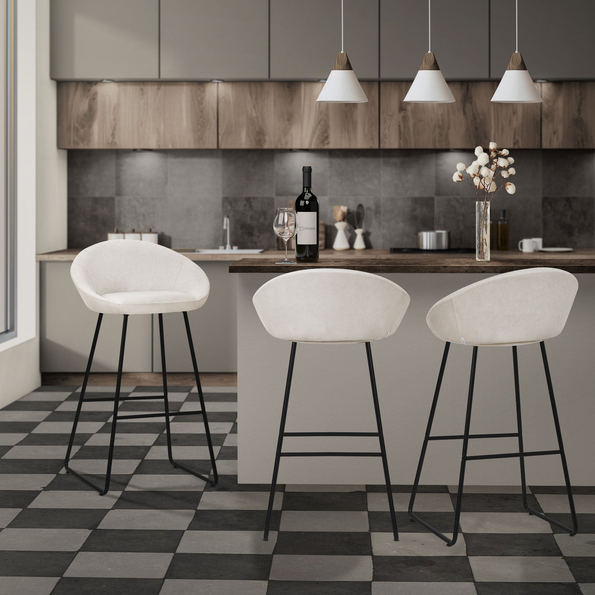 Cucina con tre sgabelli bianchi a un bancone, bottiglia di vino e decorazioni.