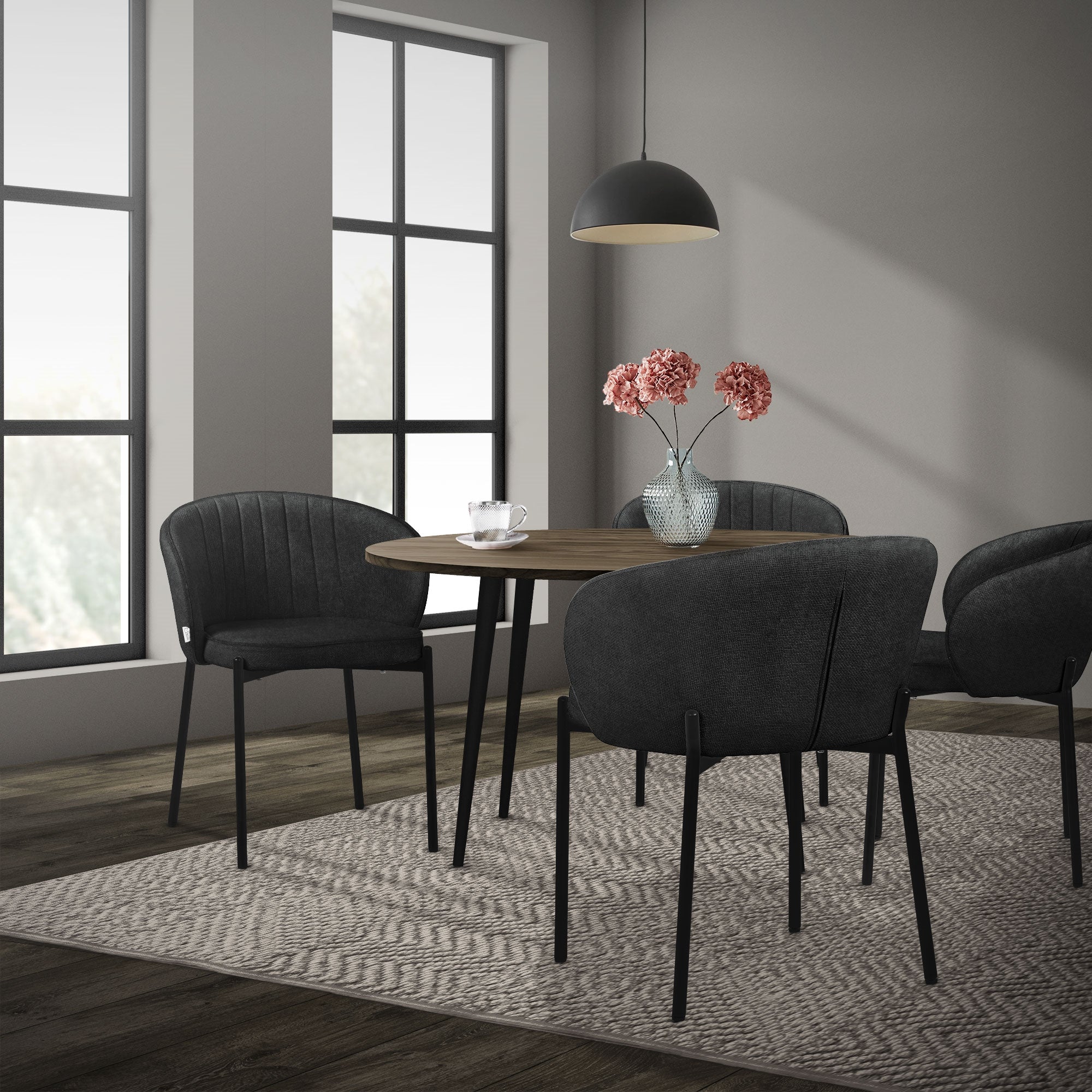 Dining room with a round table, four chairs, and a lamp.
