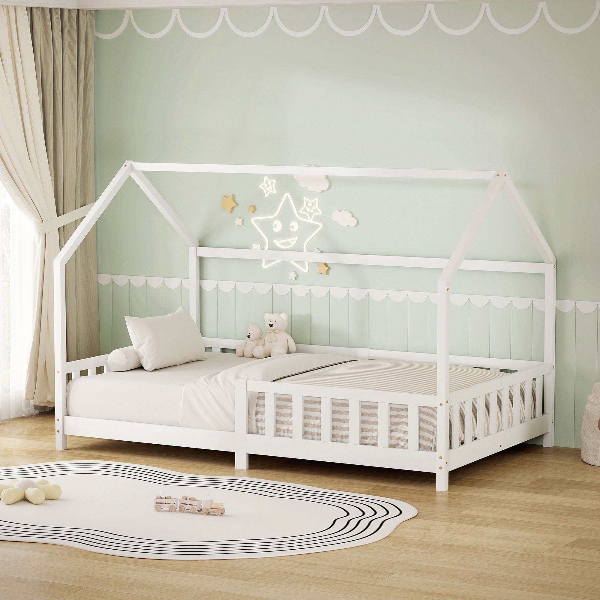 White bed in the children's room with pillows and stuffed animals.