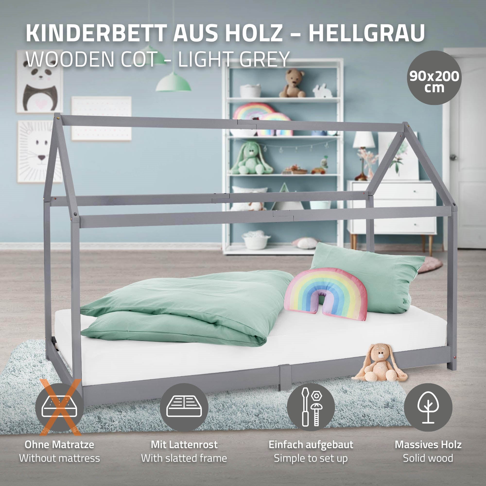 Wooden children's bed in light gray with pillow and rainbow decoration.