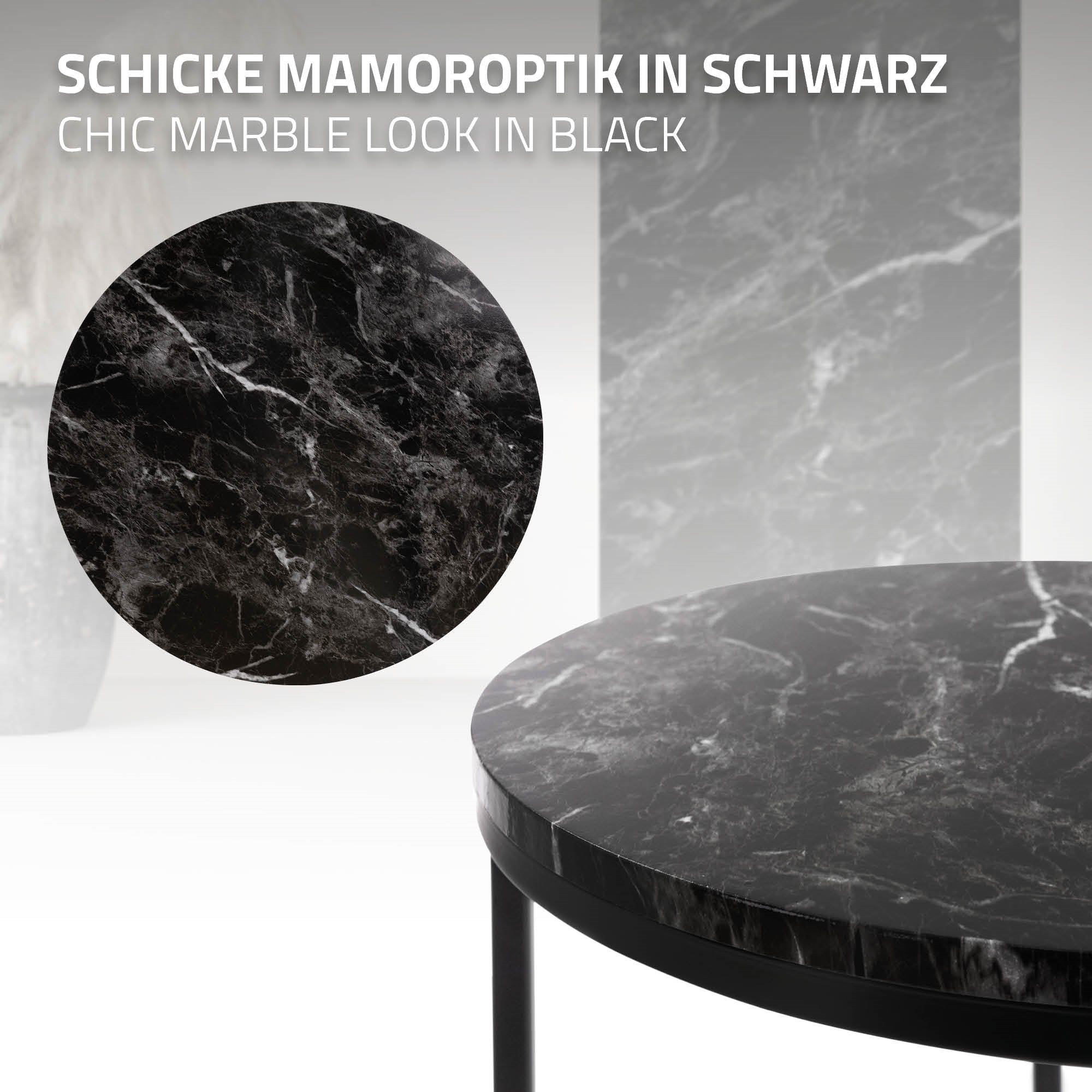 Runder Tisch mit schwarzer Marmoroptik und schwarzem Gestell.