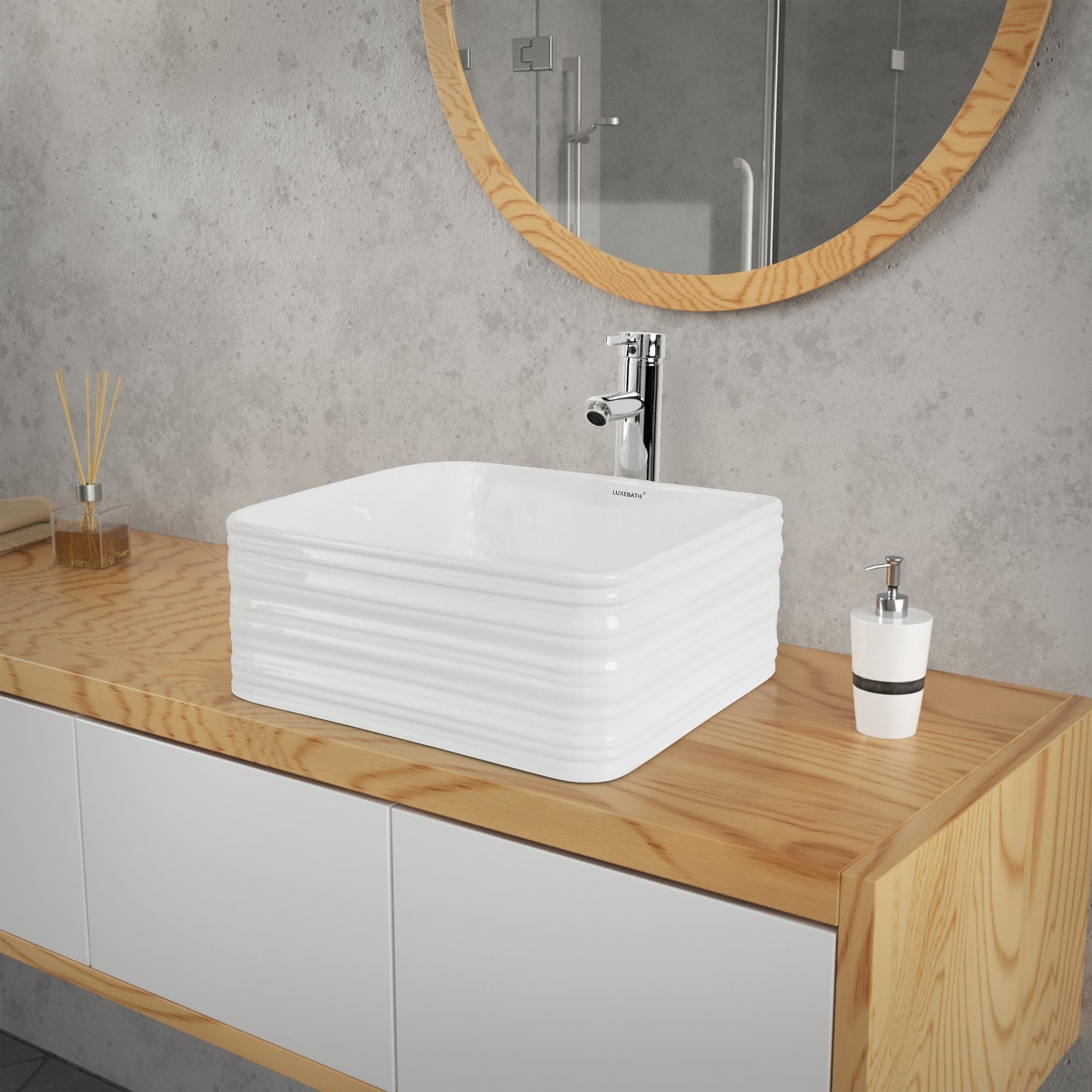 A square sink made of white material on a wooden cabinet.