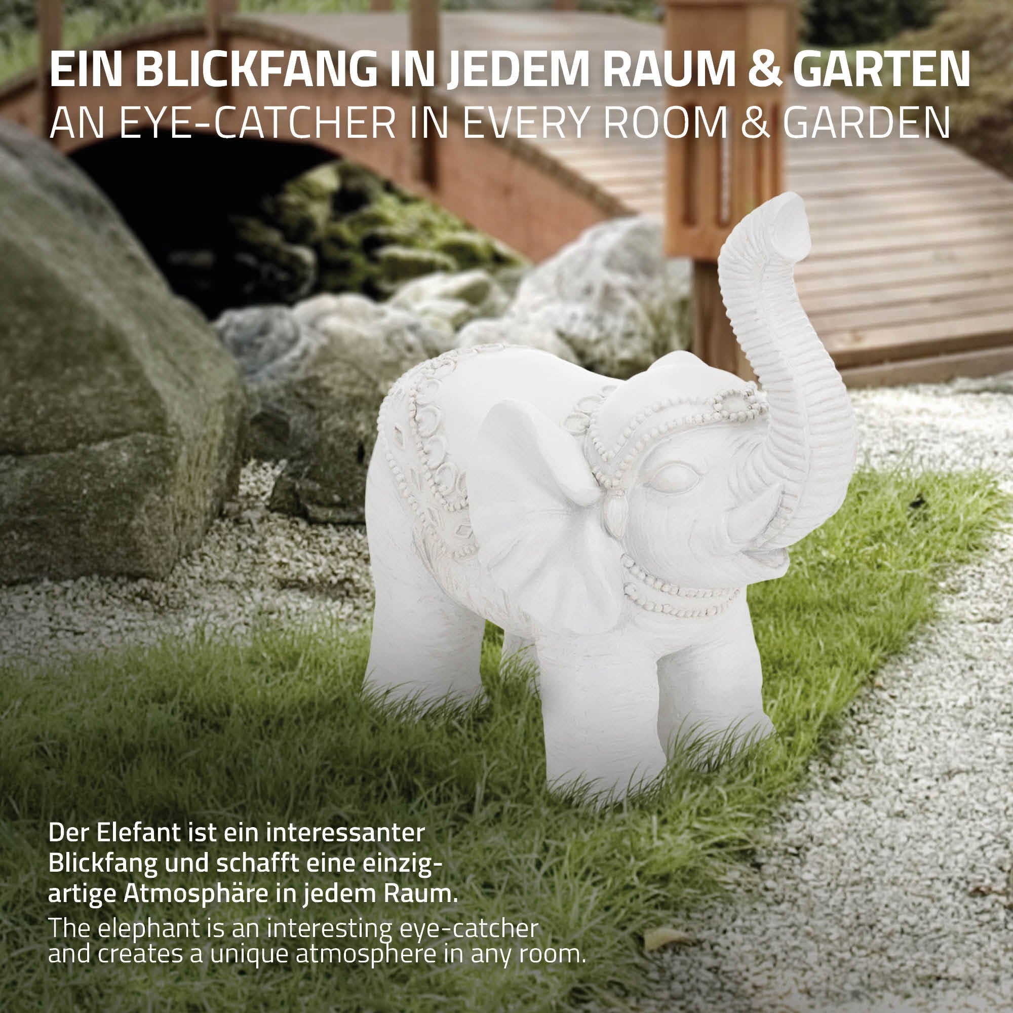 Un éléphant décoratif en pierre sur une pelouse, entouré de plantes.
