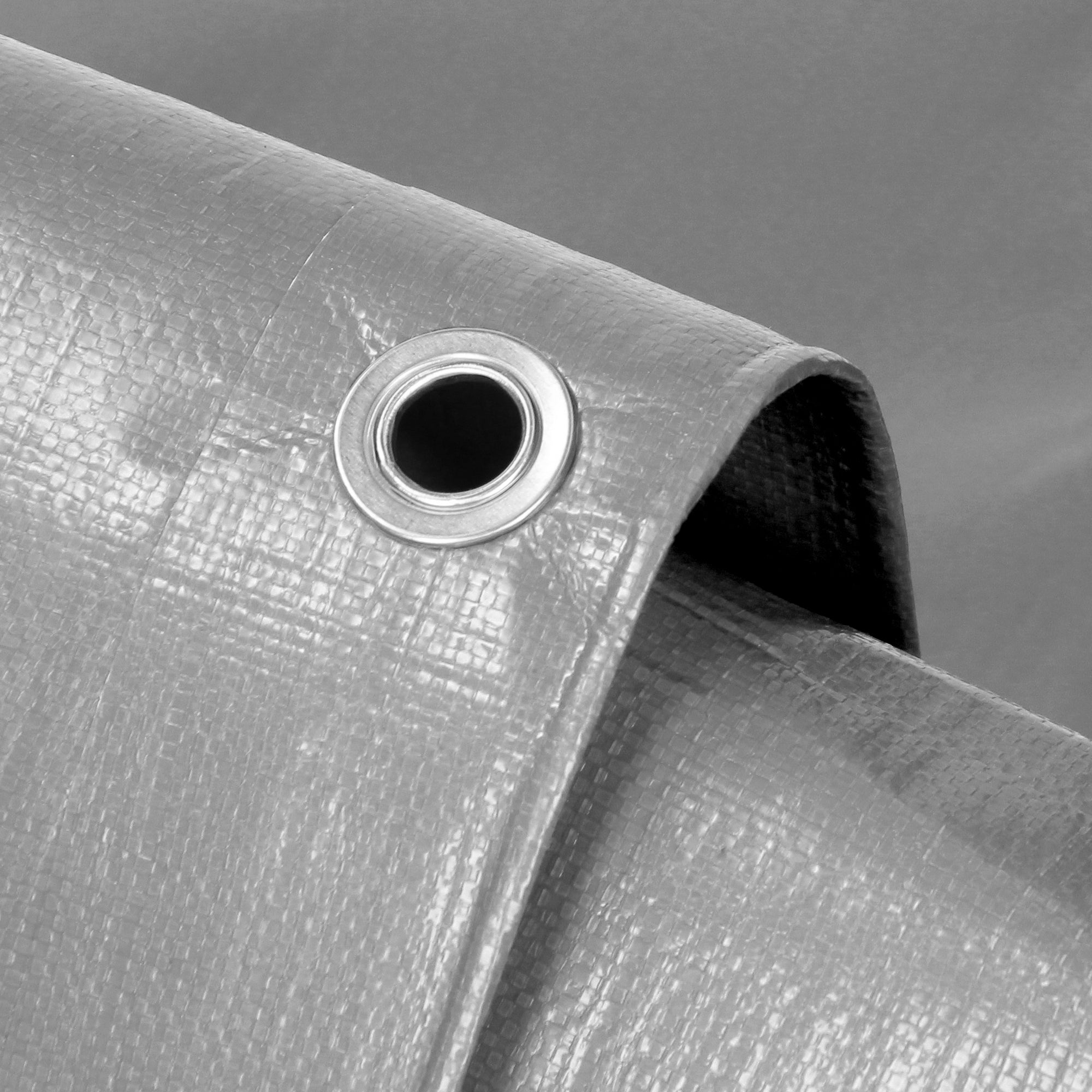 Gray tarp with a metal ring in the corner.