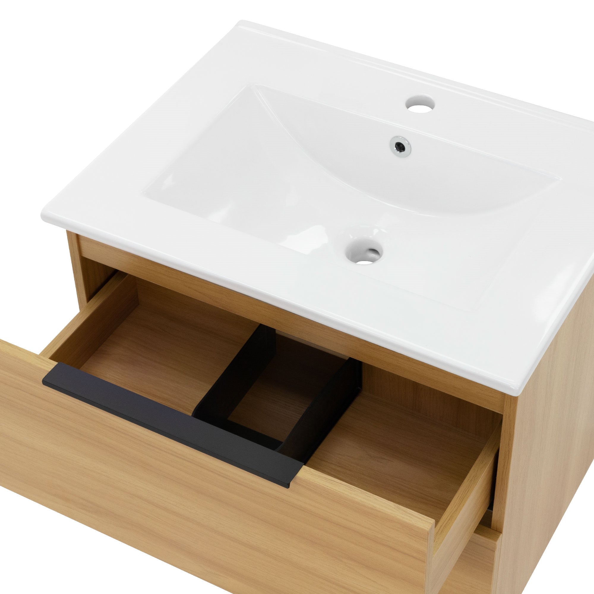 Close-up of a washbasin with an open drawer compartment.