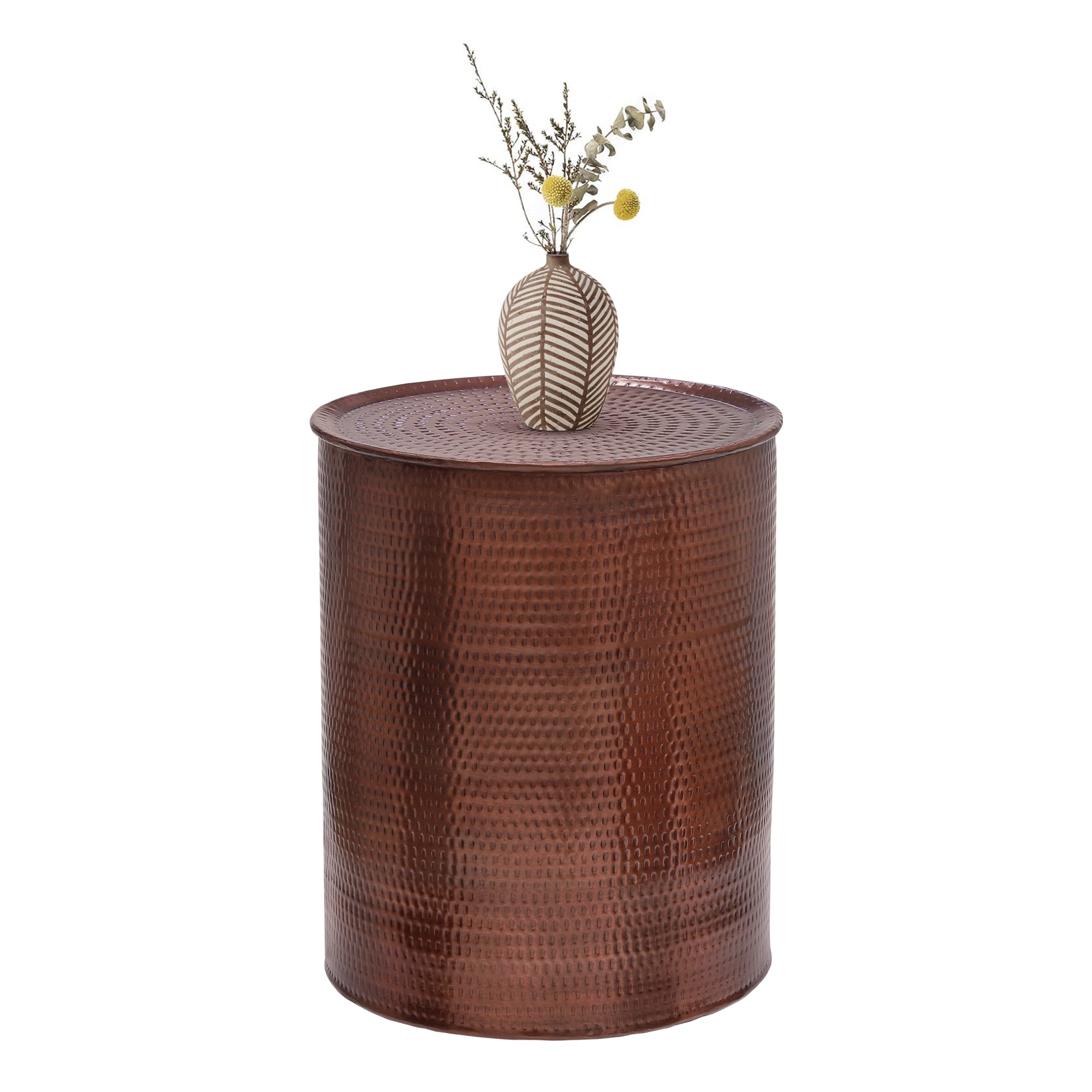 A round, brown side table with a vase and branches.