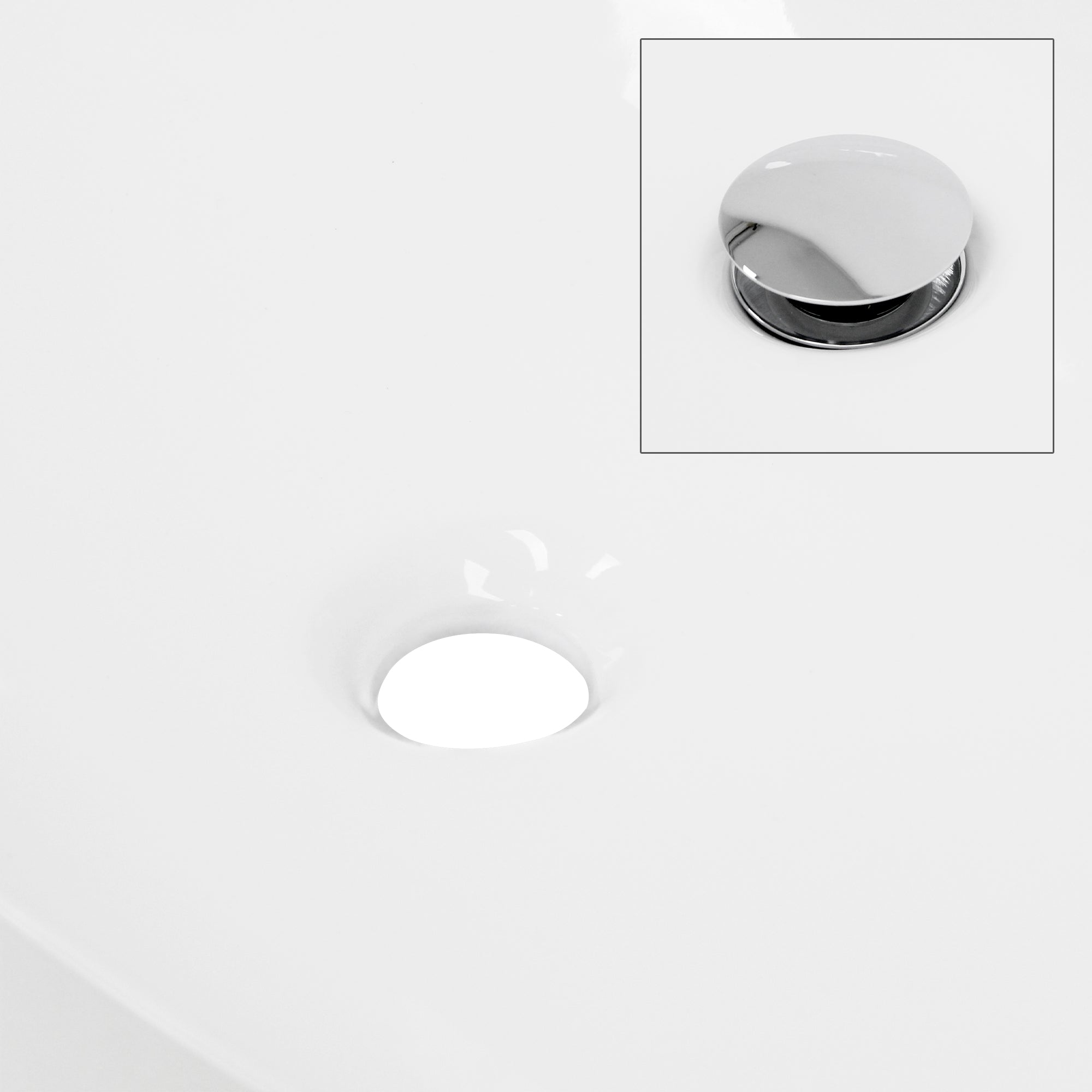 White sink drain with shiny stopper.