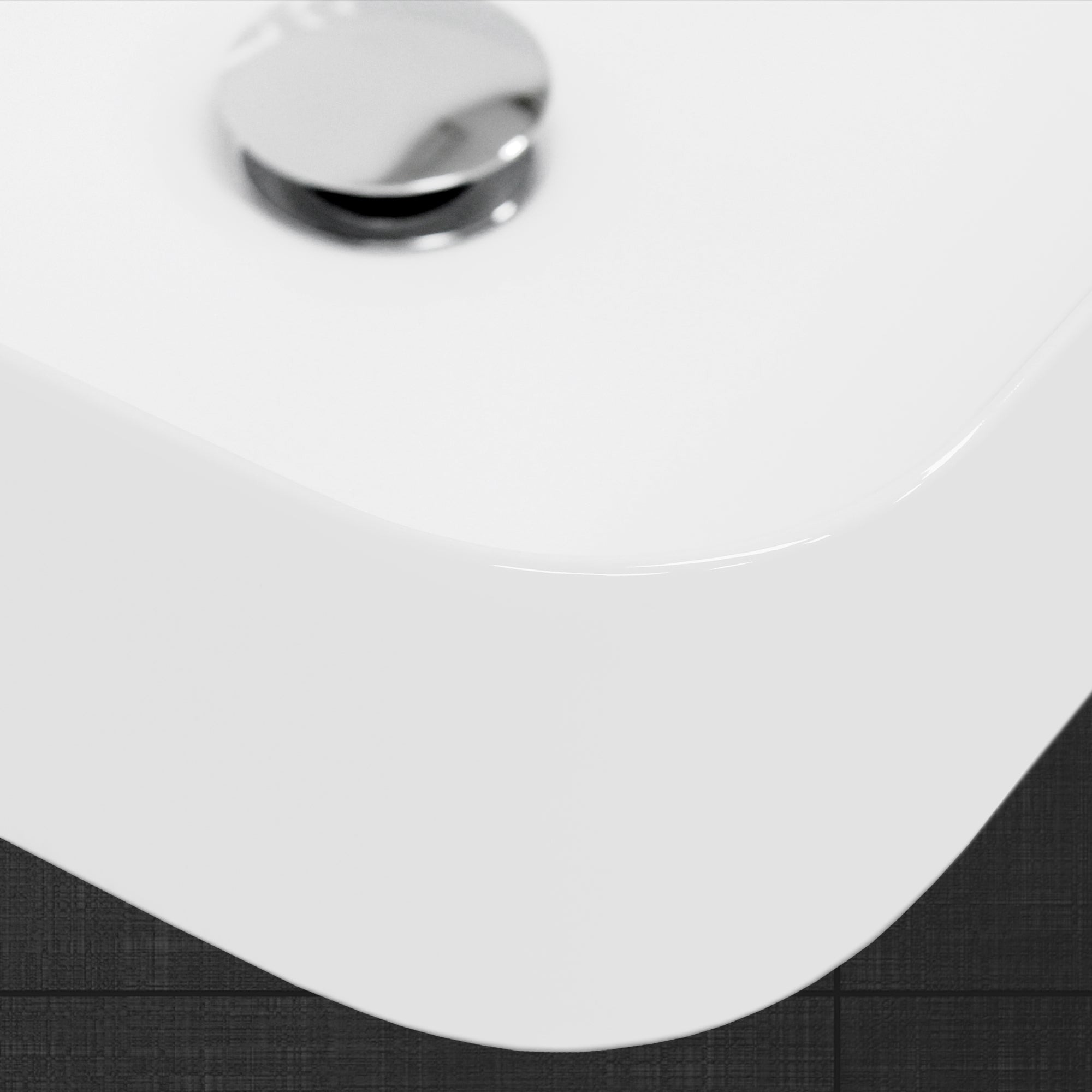 Close-up of the edge of a white bathtub.
