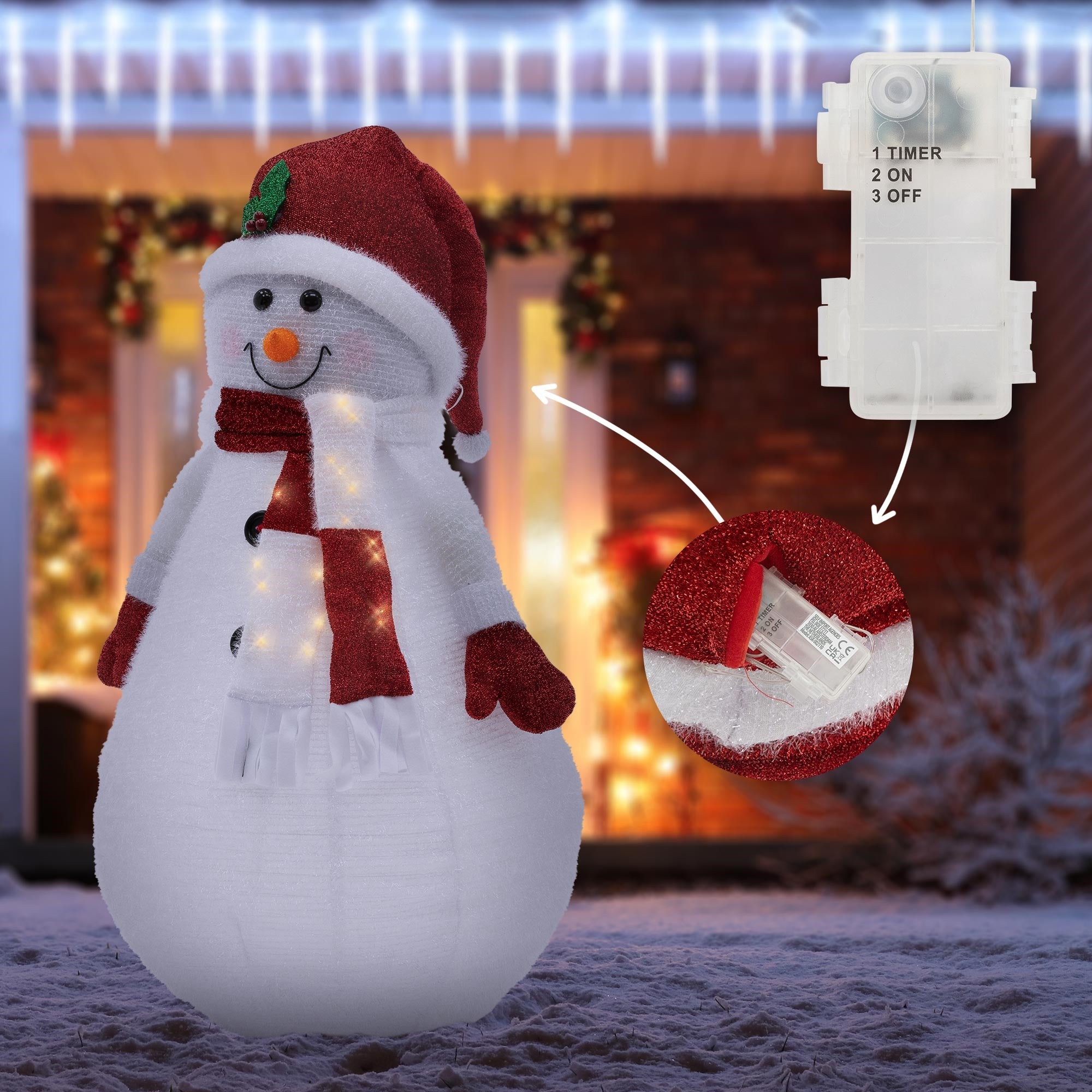 Un bonhomme de neige avec un chapeau rouge et une écharpe, entouré de lumières et d'un interrupteur.