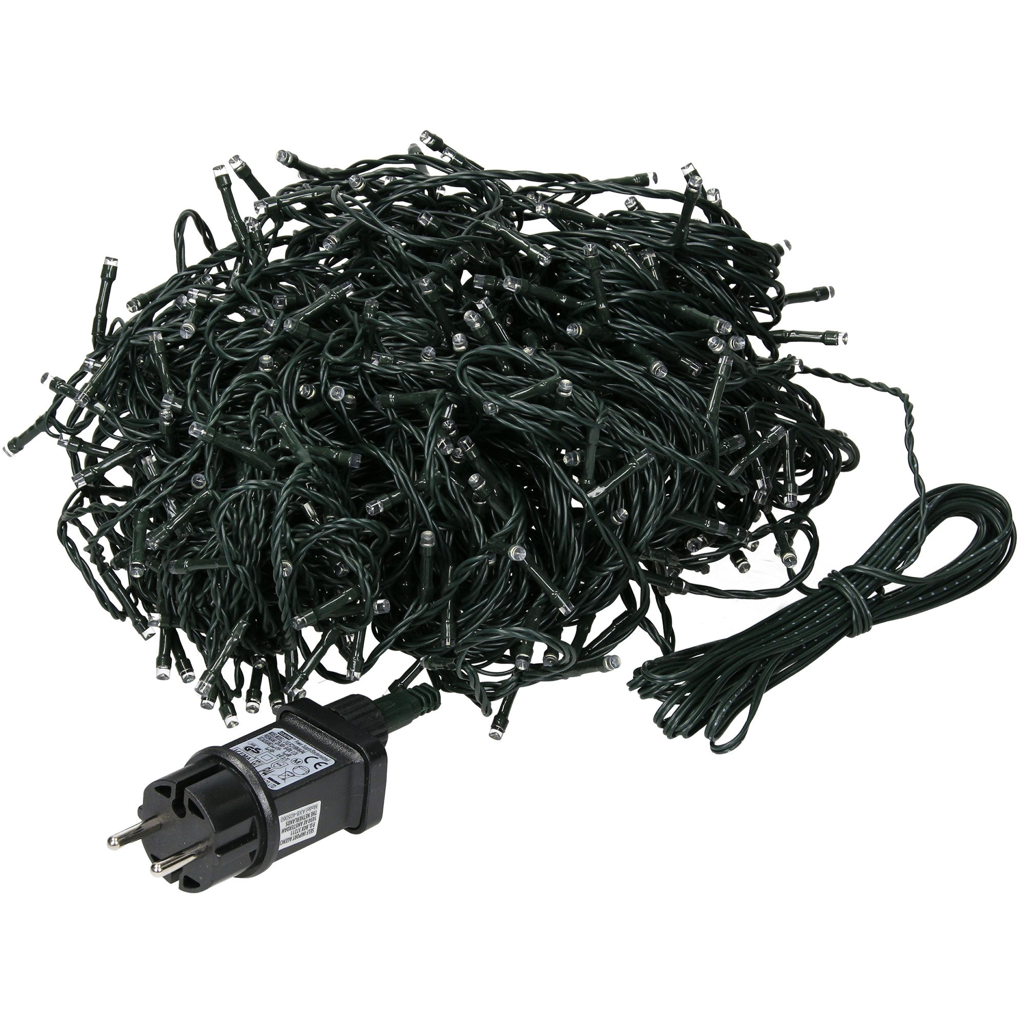 A pile of green lights with plugs, messily spread out on a table.