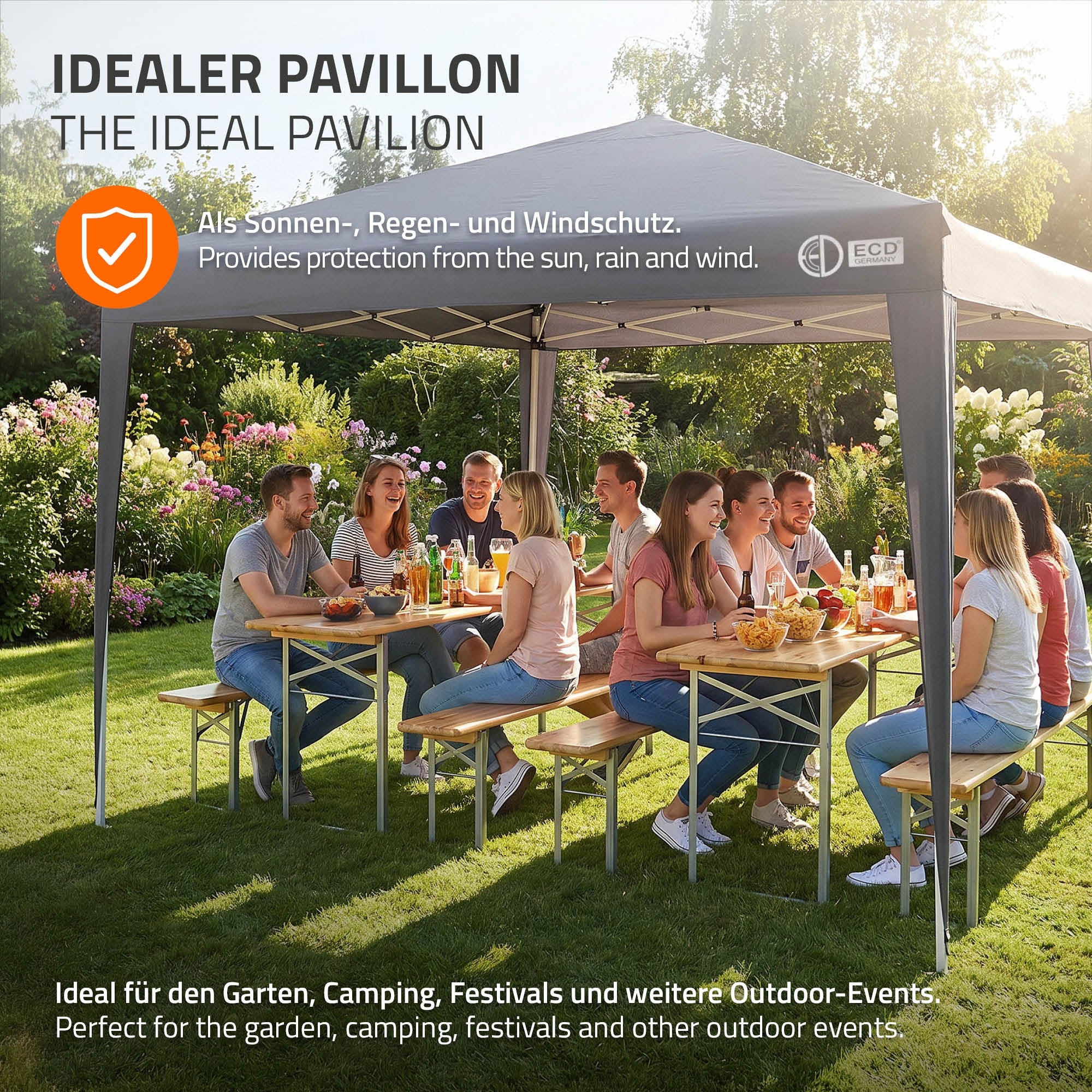 Gruppe von Menschen genießt ein Essen unter einem Pavillon im Garten.