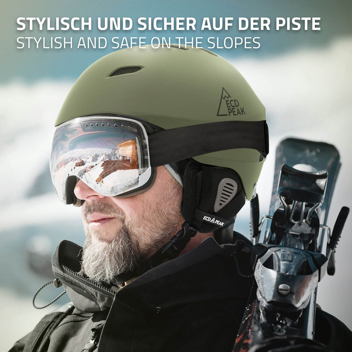 Mann mit grünem Skihelm und Skibrille auf der Piste.