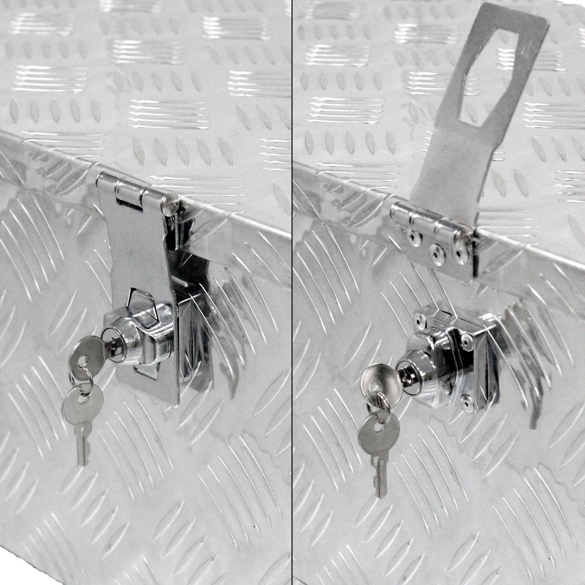 Close-up of the lock of a silver box with two keys.