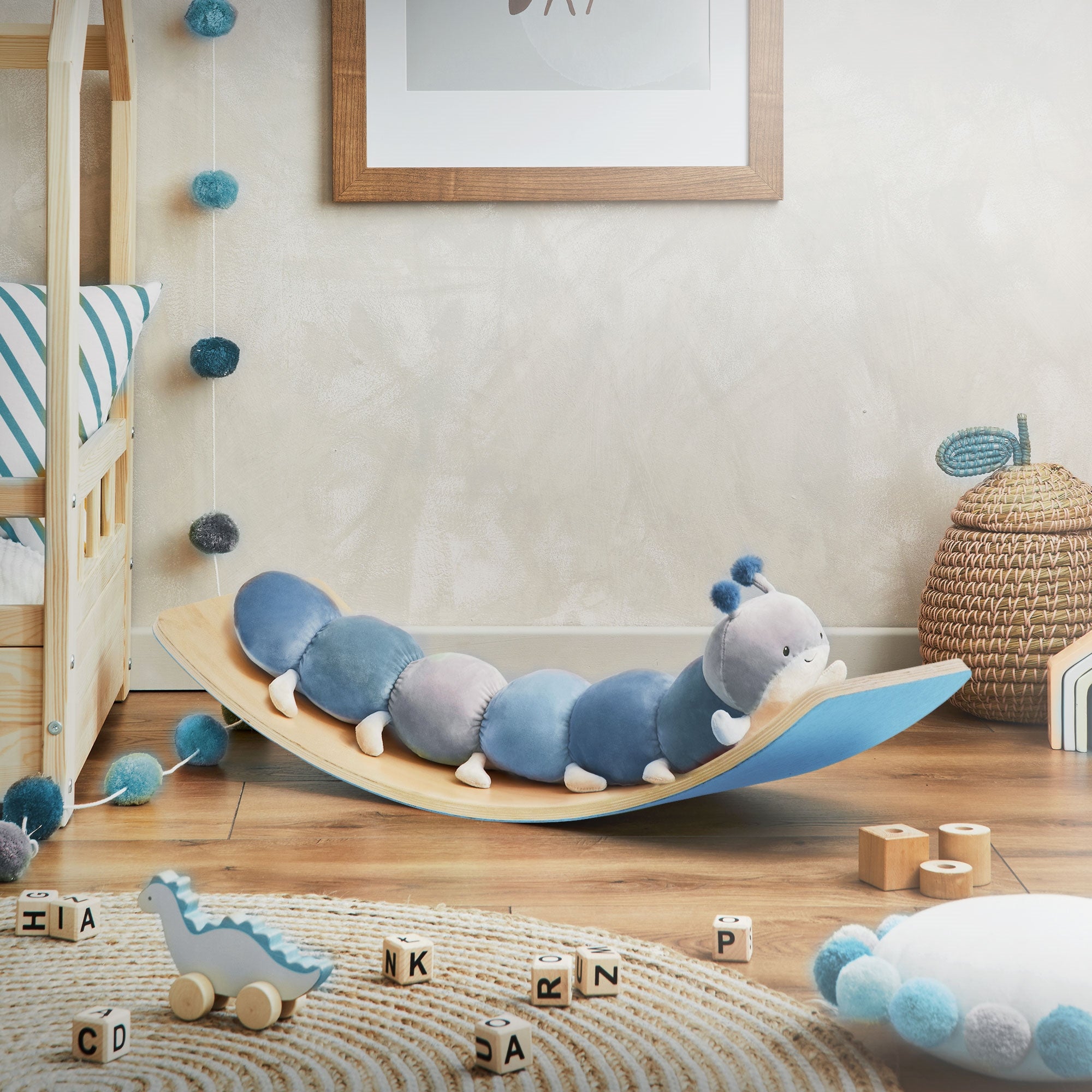 Wooden board with blue plush toys, playroom with decoration.