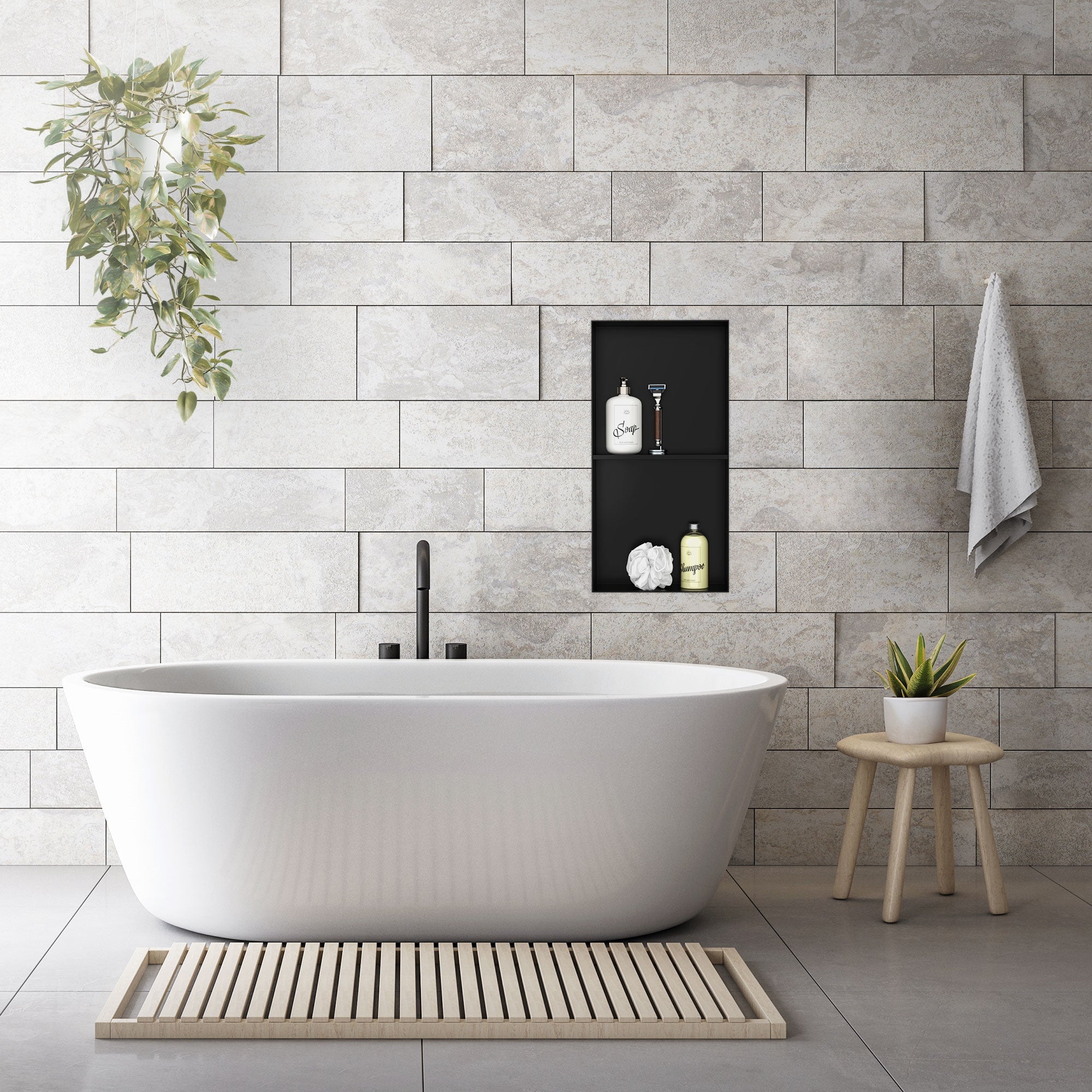 Bathroom with freestanding bathtub and black wall niche.