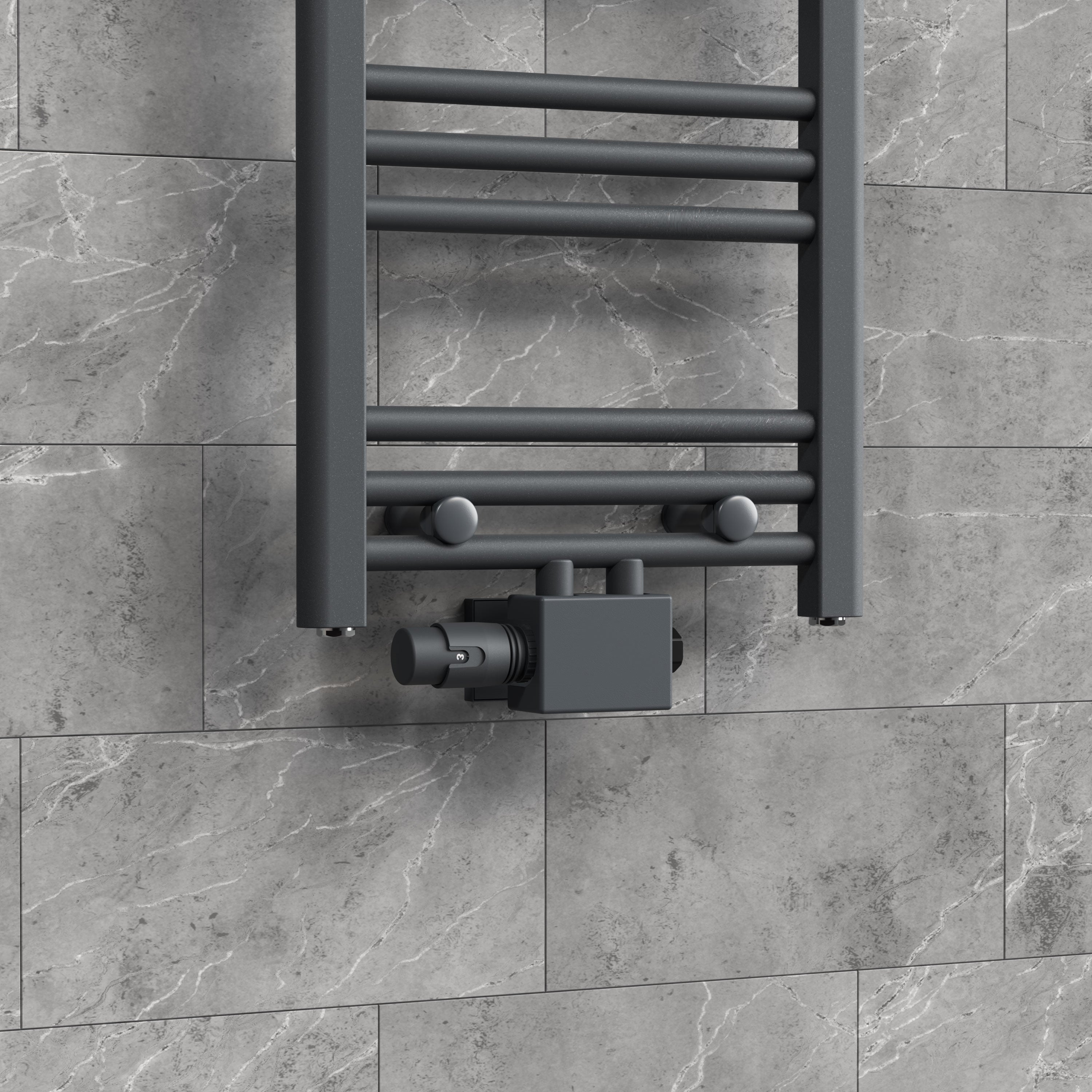 Radiator with thermostat on gray wall tile.