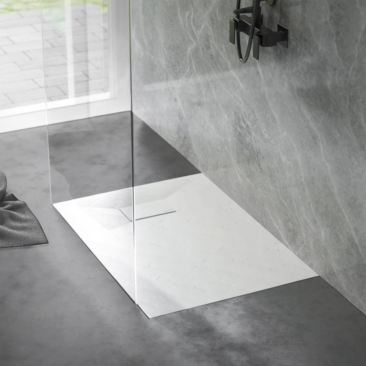 Shower area with non-slip shower tray and glass shower partition.