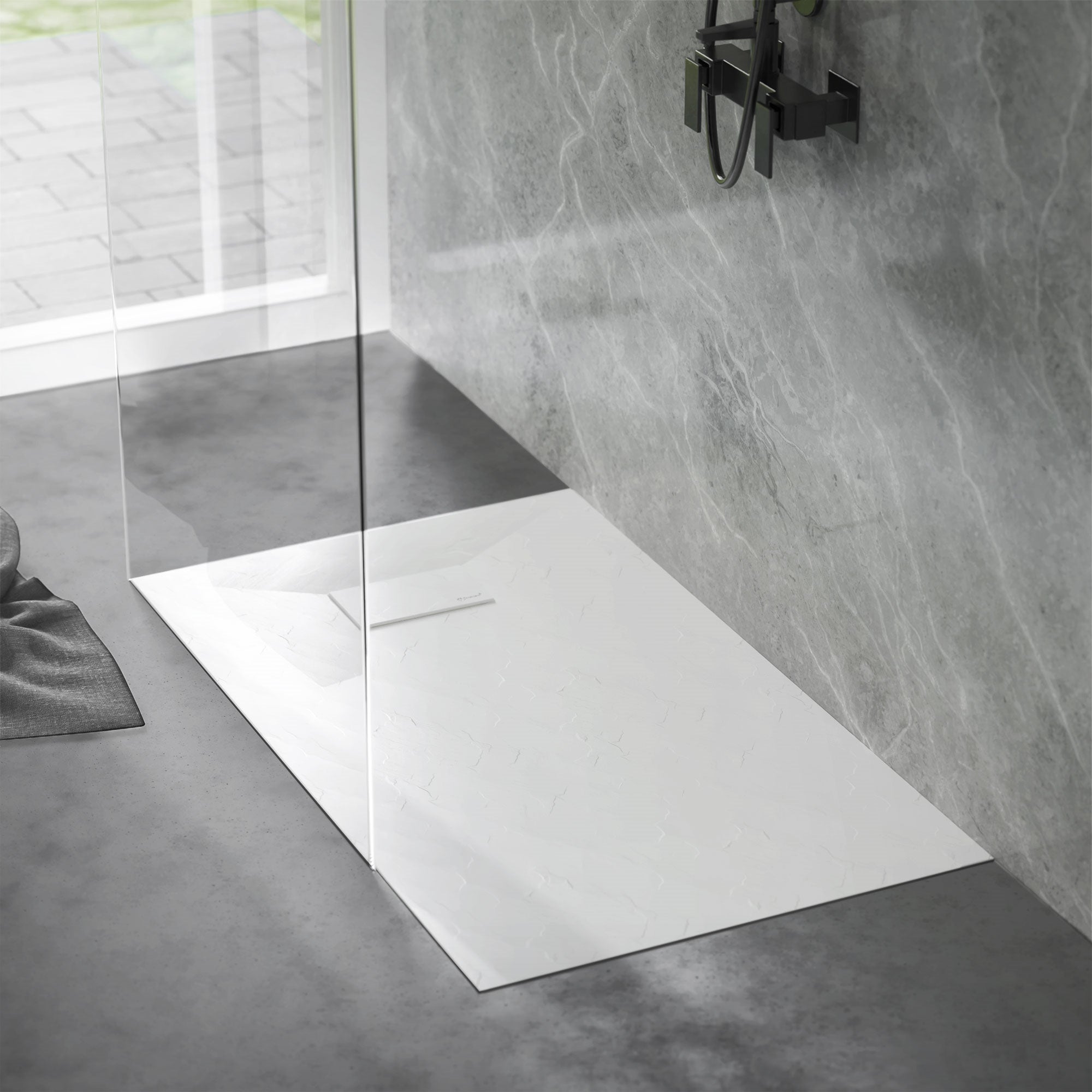 Shower tray in a modern shower with glass wall.