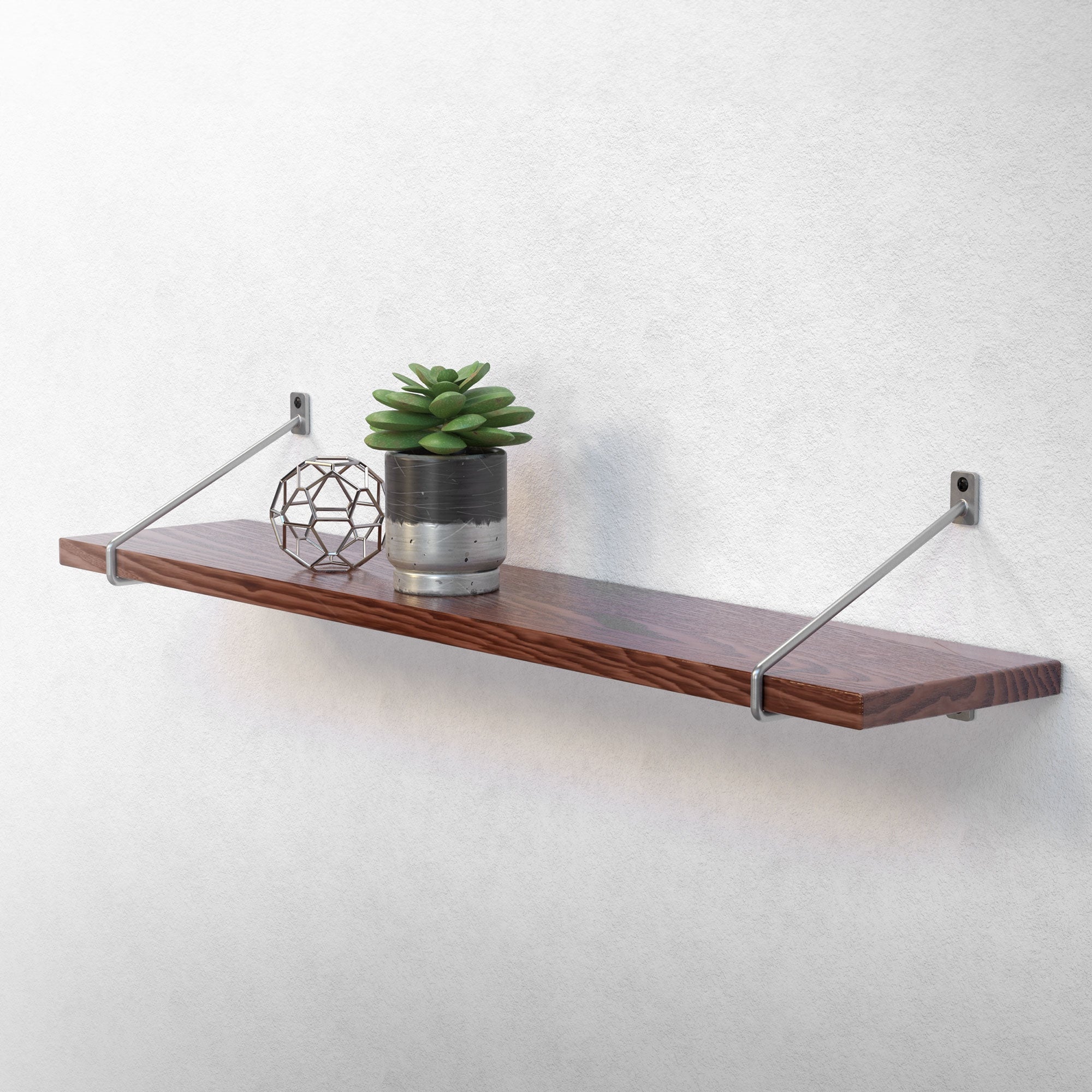 Wooden shelf with plants and decoration on a wall.