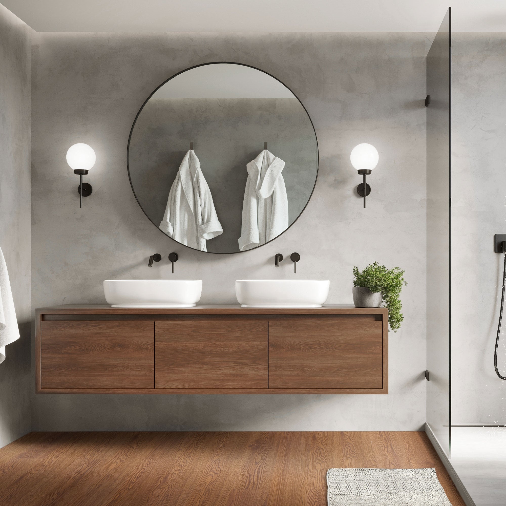 Bagno moderno con doppio lavabo e specchio rotondo.