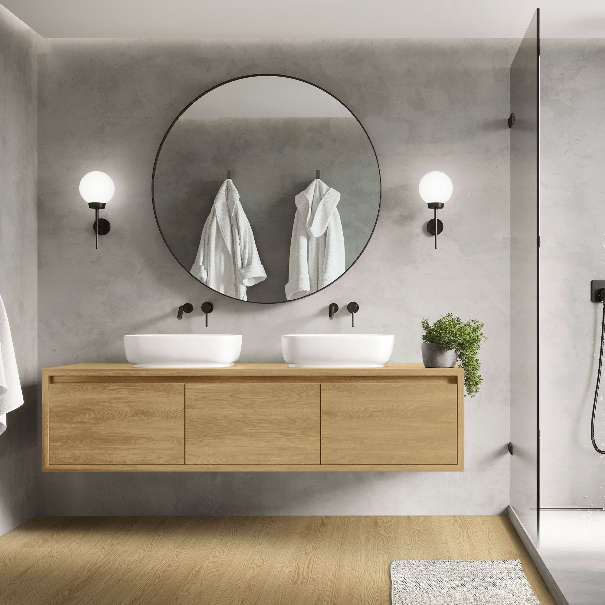 Modernes Badezimmer mit runden Spiegeln und zwei Waschbecken.