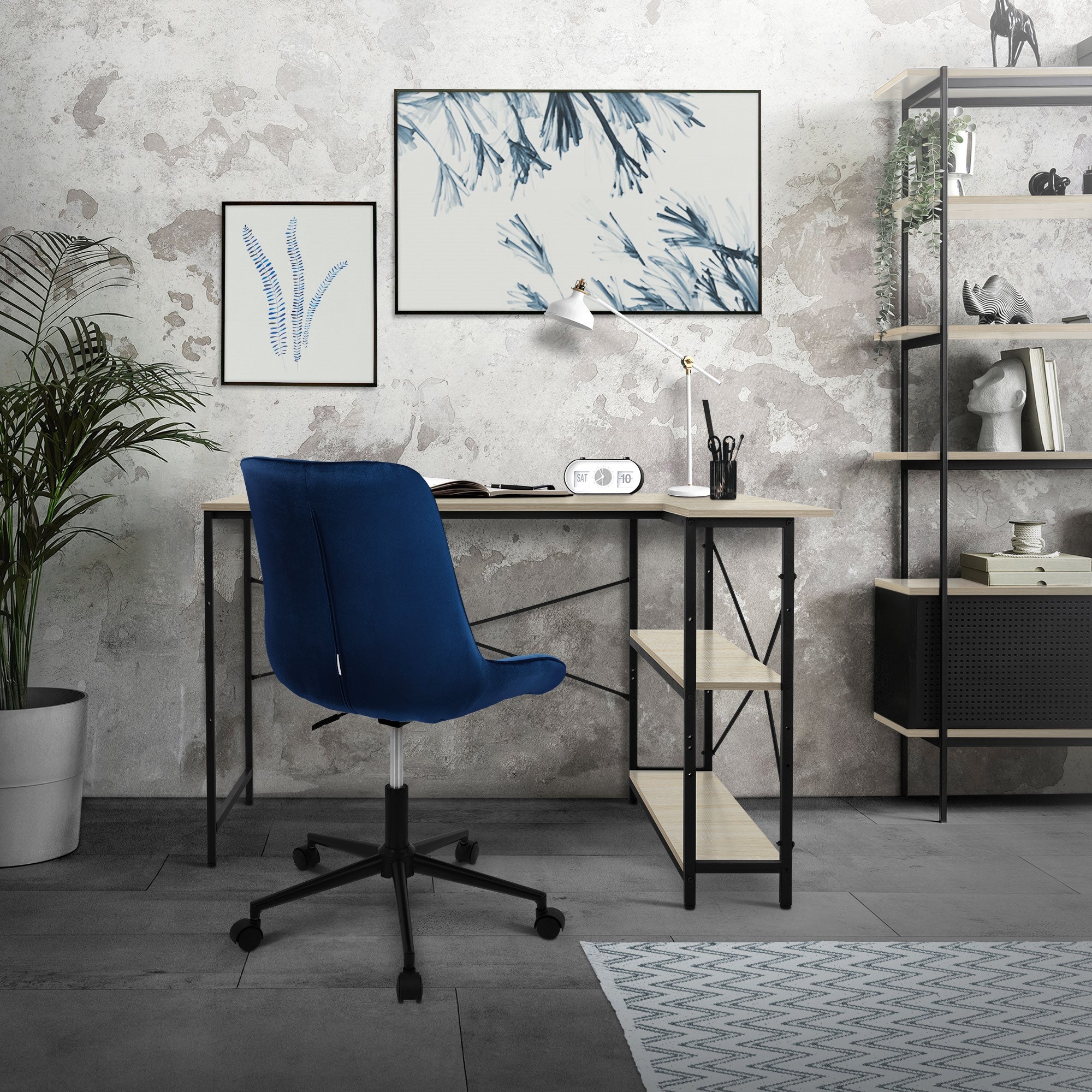 Office desk with blue chair, plants, and pictures on the wall.
