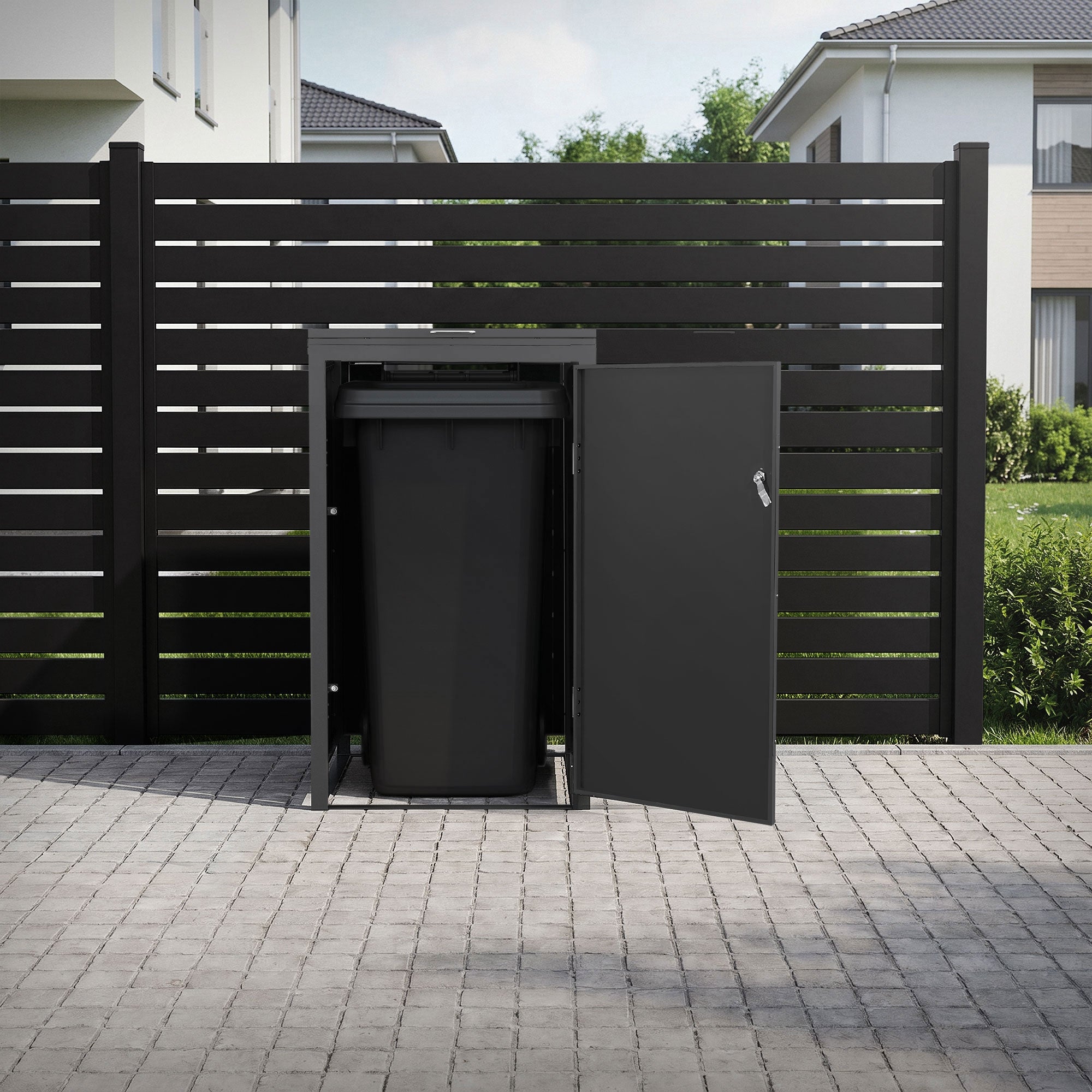 Black trash can container stands open behind a fence in a garage.