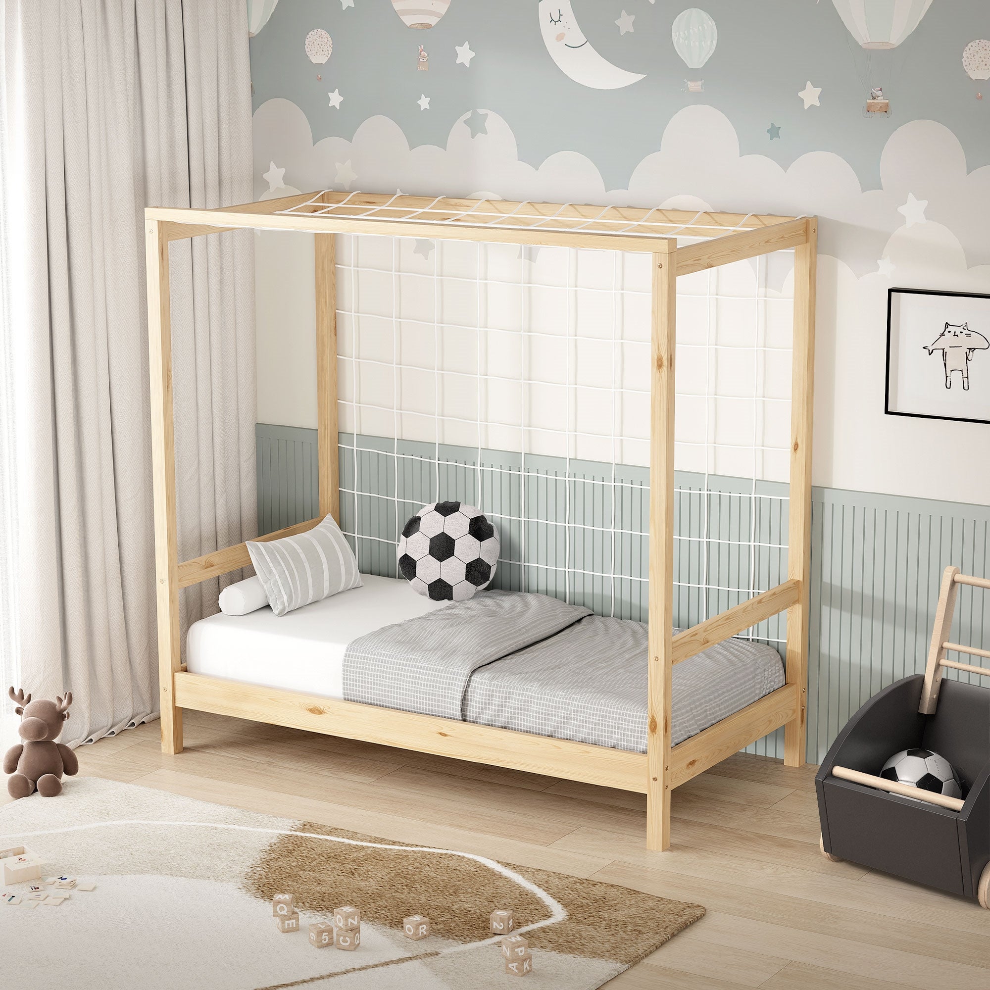 A wooden children's bed with a net and a soccer ball on the mattress.