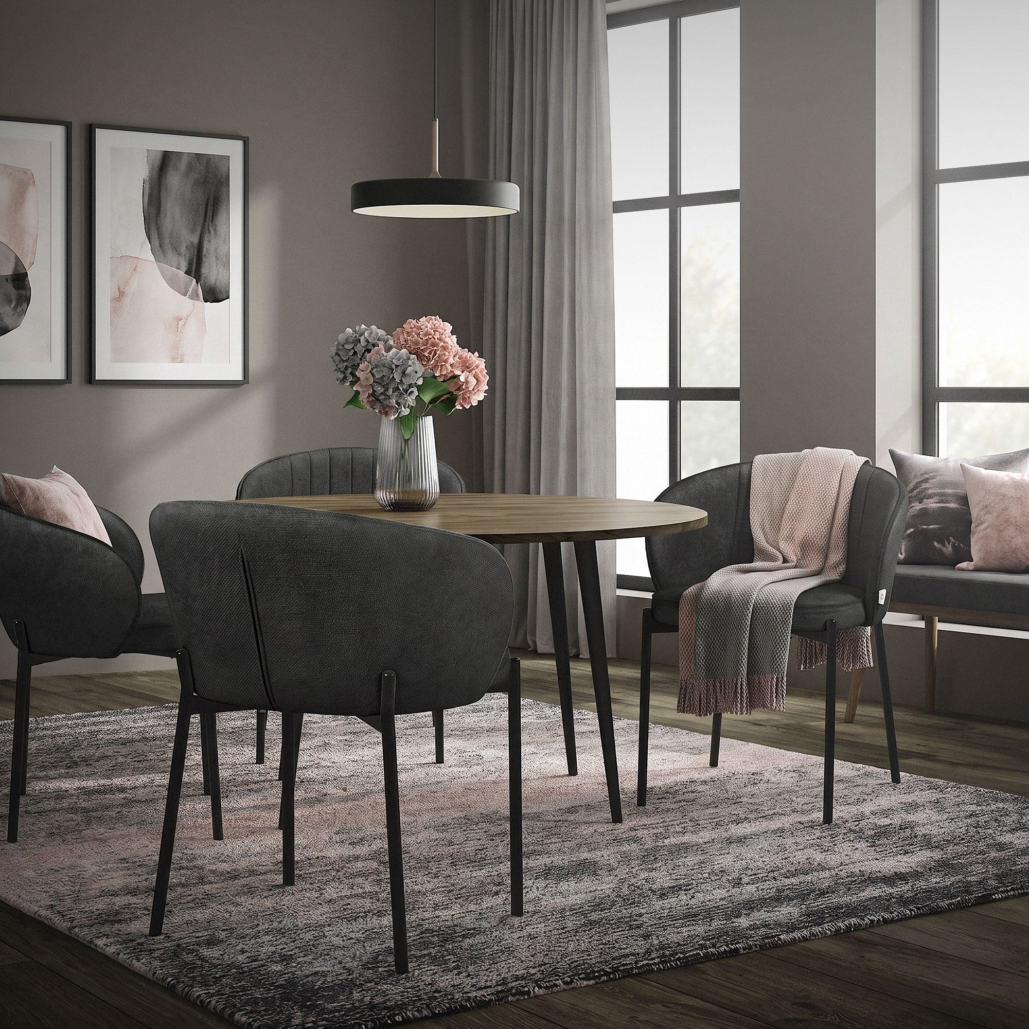 A dining room with a round table, chairs, and a vase with flowers.