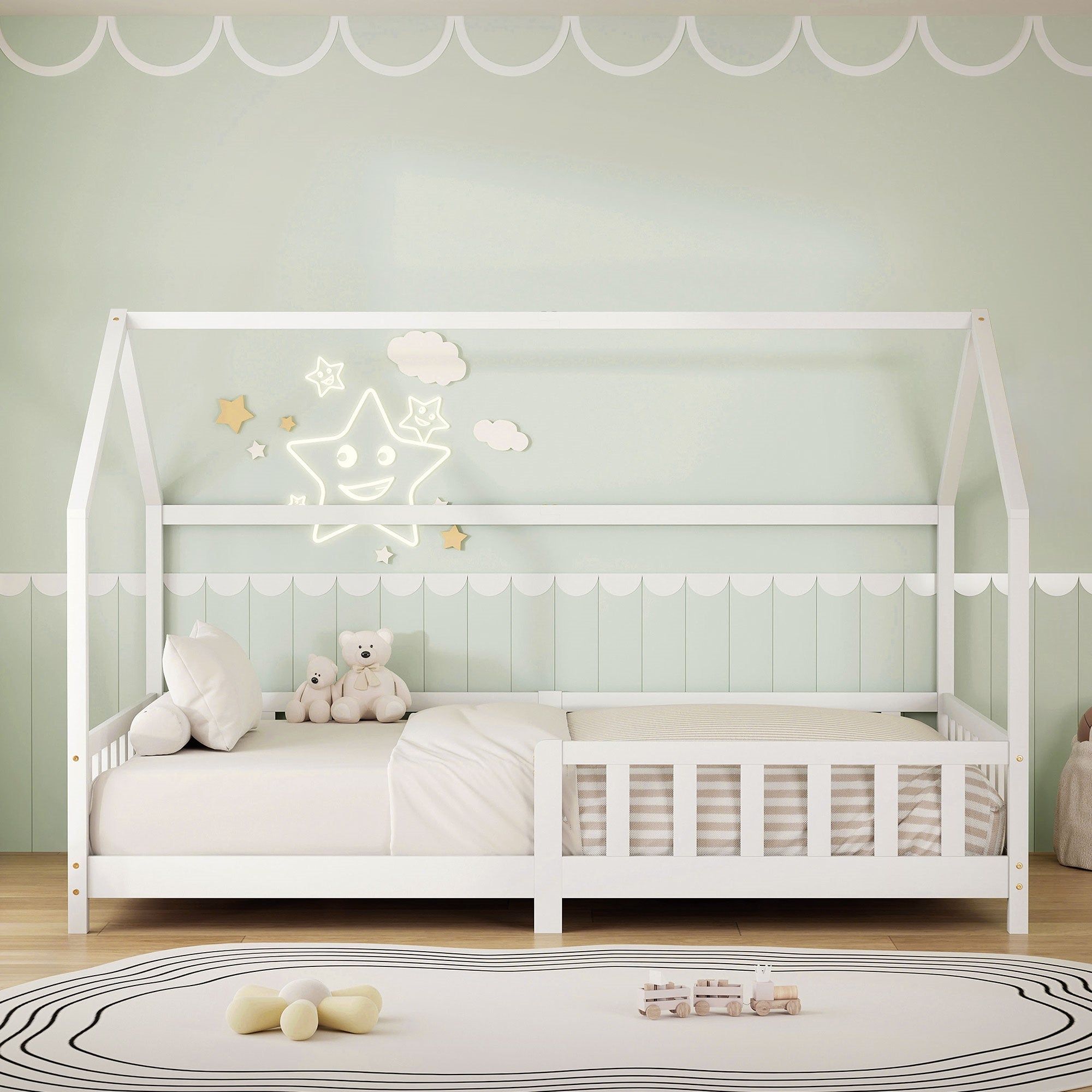 White children's bed with pillows and toys on a carpet.