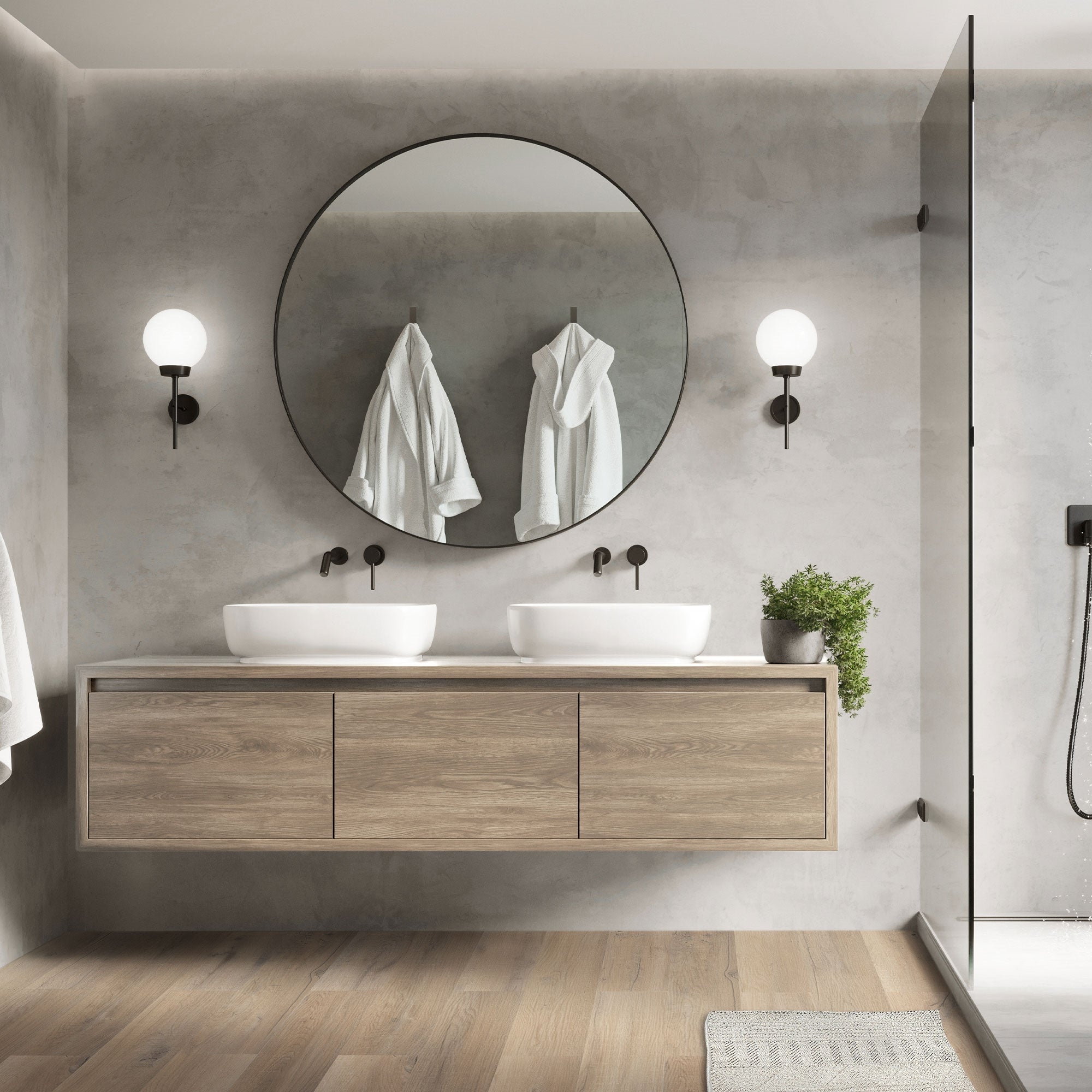 Salle de bain moderne avec deux lavabos et un miroir rond.