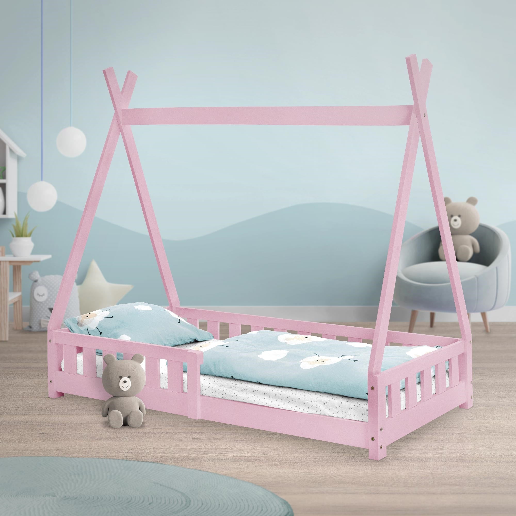 Un letto rosa con cuscini e coperte in una cameretta.