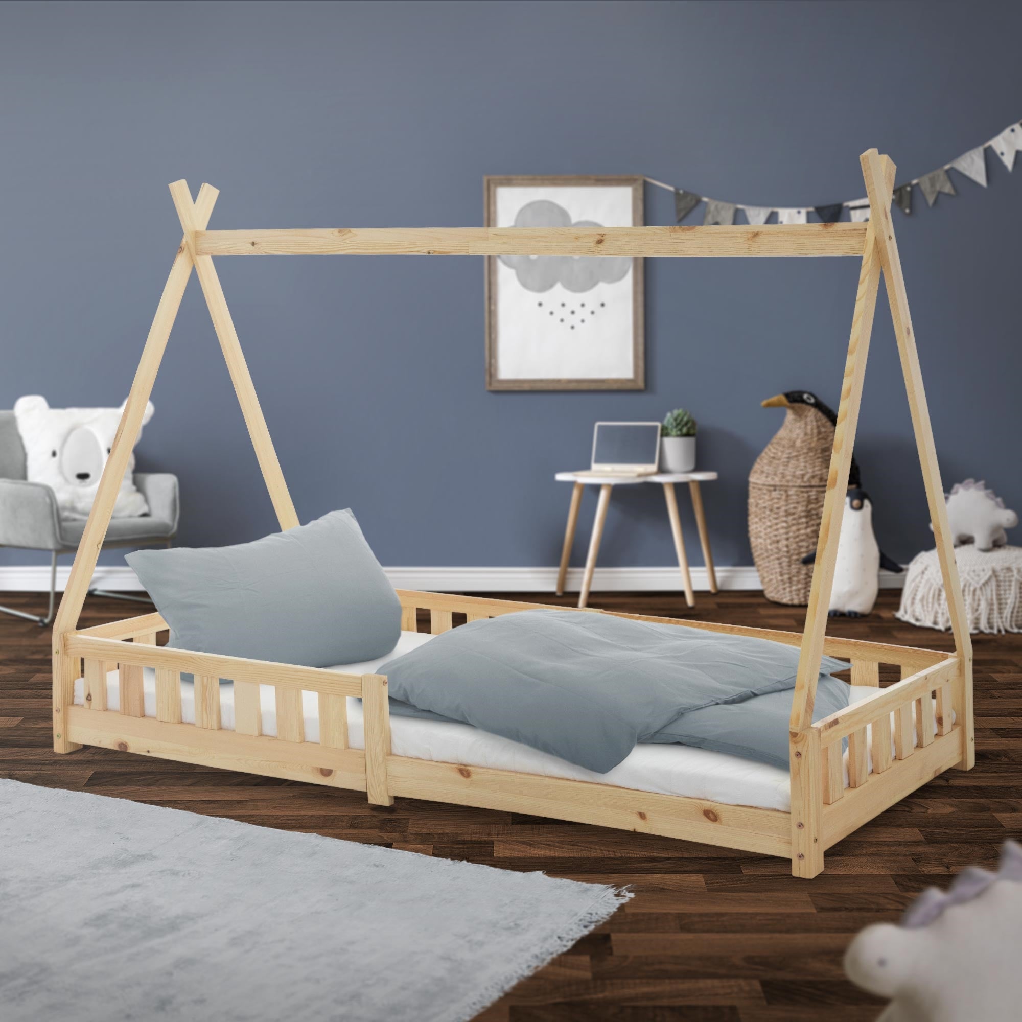 A wooden children's bed in natural color with pillow and blanket in the room.
