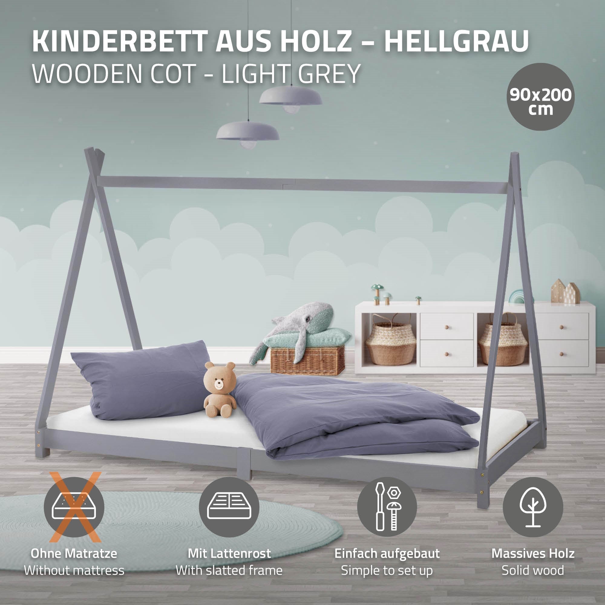 Kinderbett aus Holz in hellgrau mit Kissen und Decke.