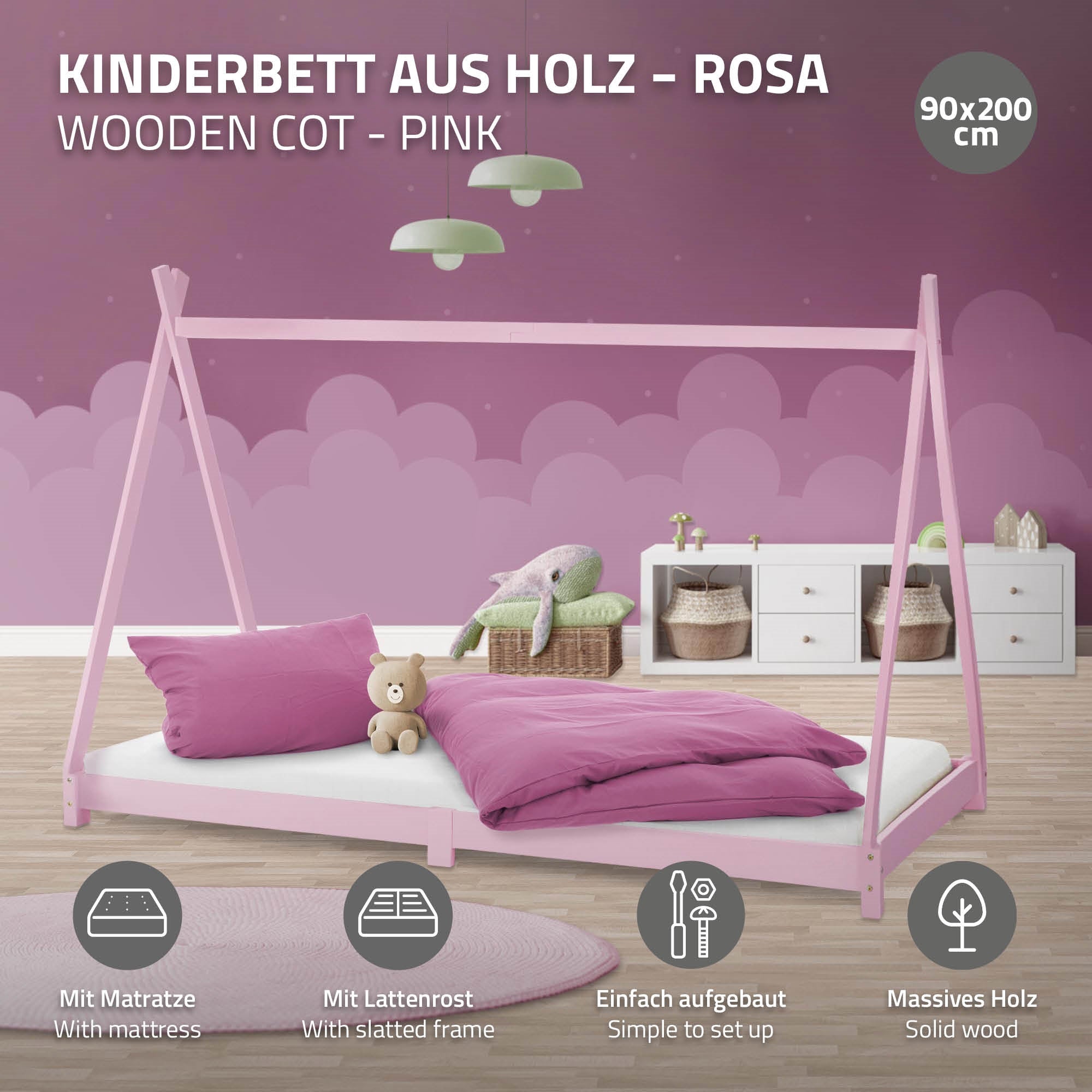 Ein rosa Kinderbett aus Holz mit Matratze und Kissen.