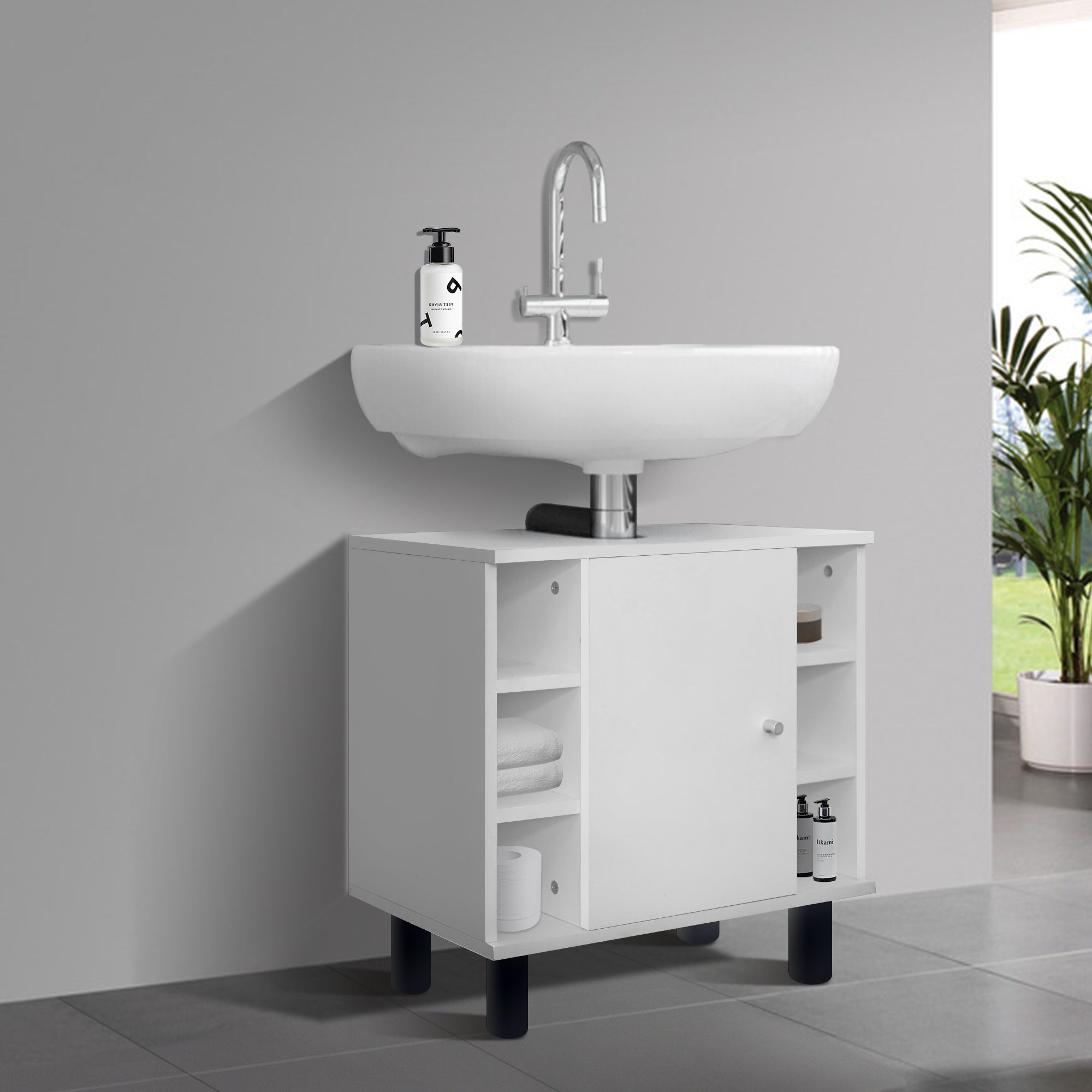 Mobile sottolavabo bianco con lavabo e piante sullo sfondo.