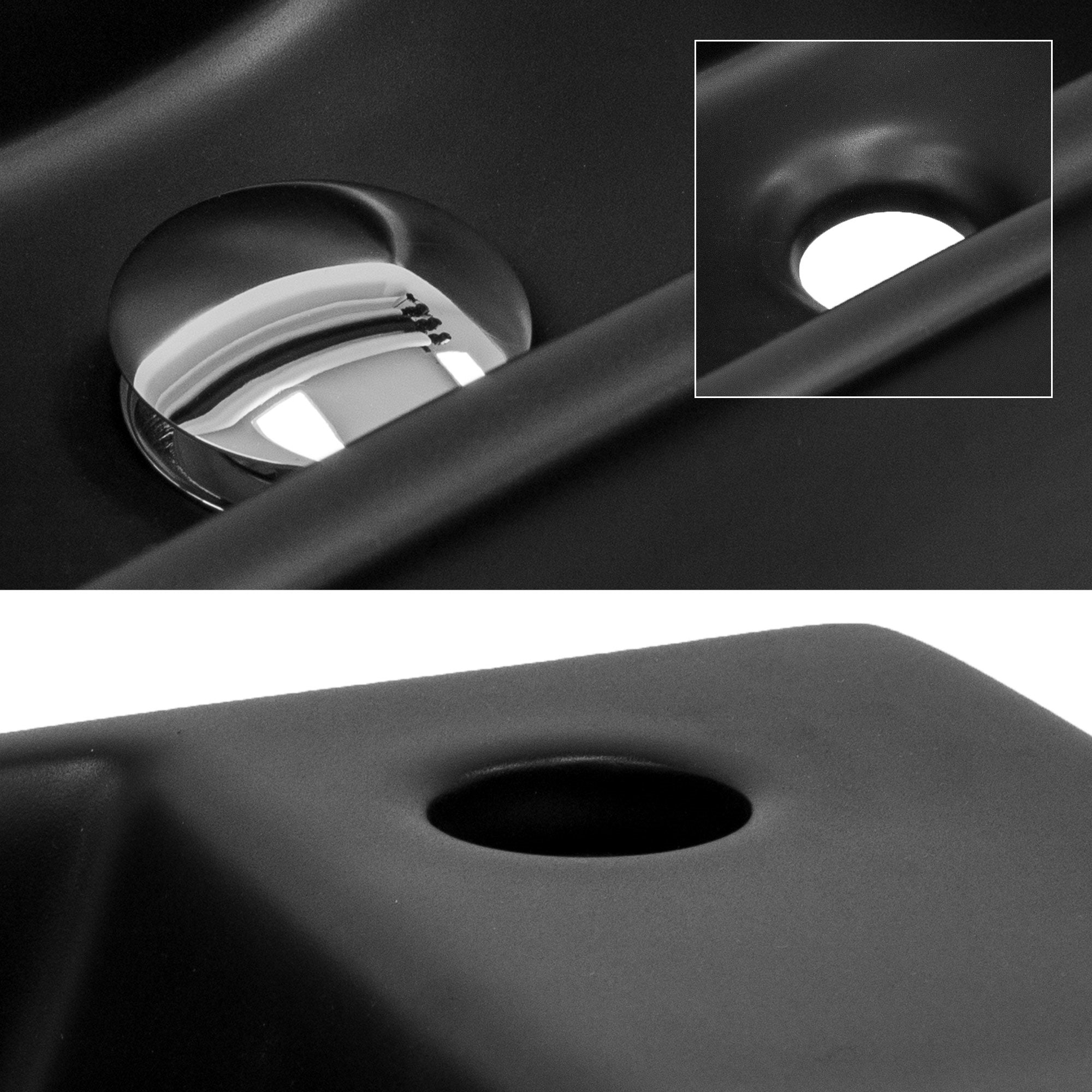 Close-up of a black sink with a round drain.