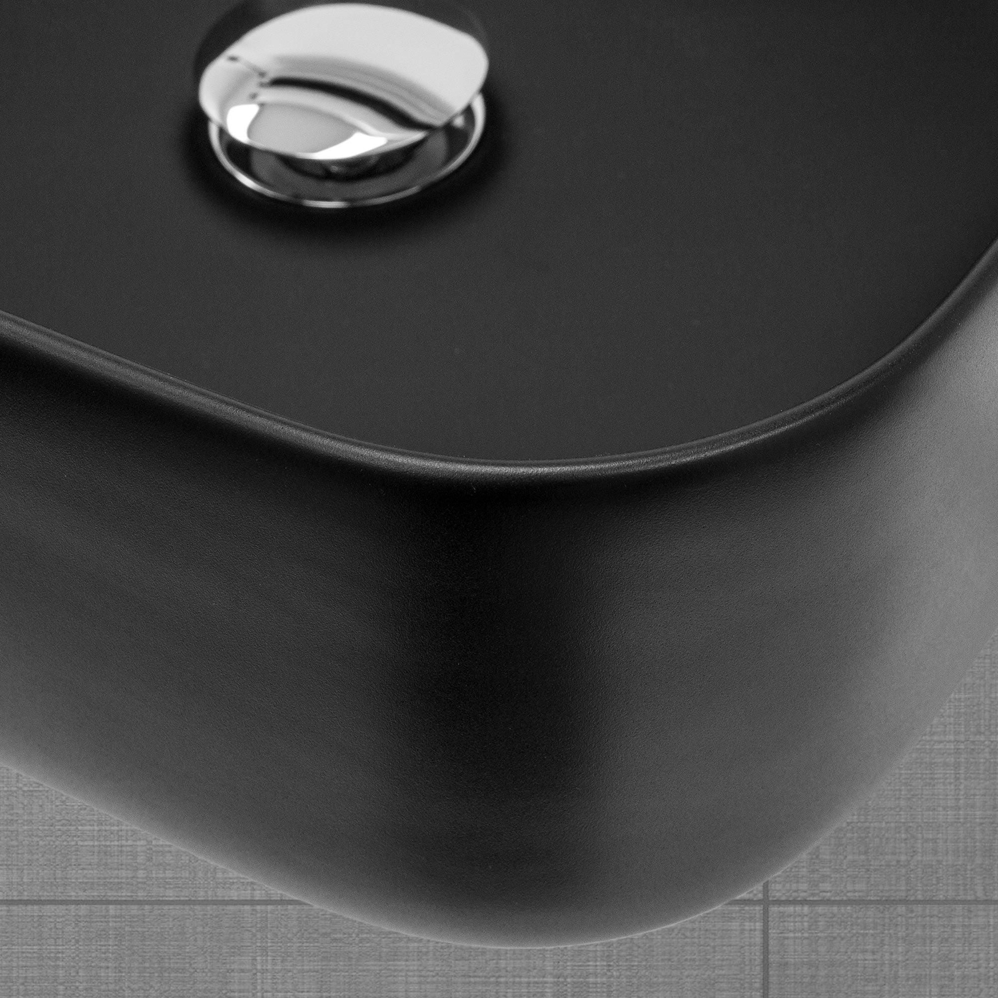 Close-up of the drain of a black sink.