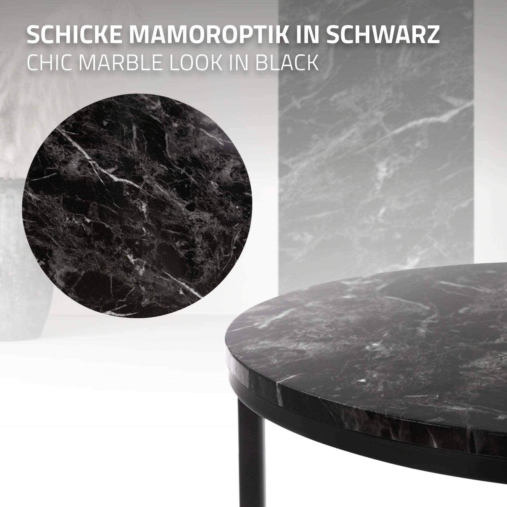 Ein runder Tisch mit schwarzer Marmoroptik auf einer glatten Oberfläche.
