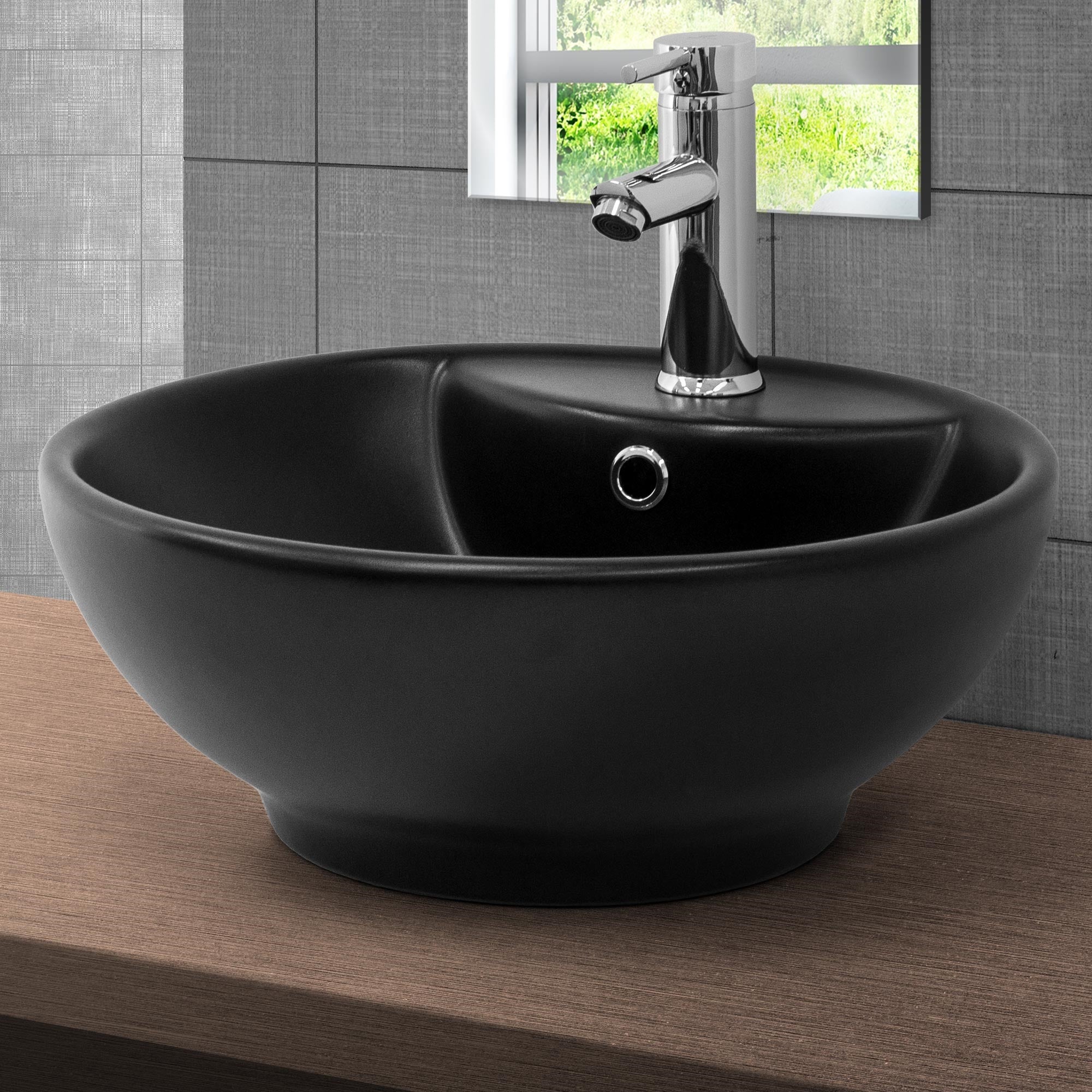 Lavabo nero su uno scaffale in legno con rubinetto.